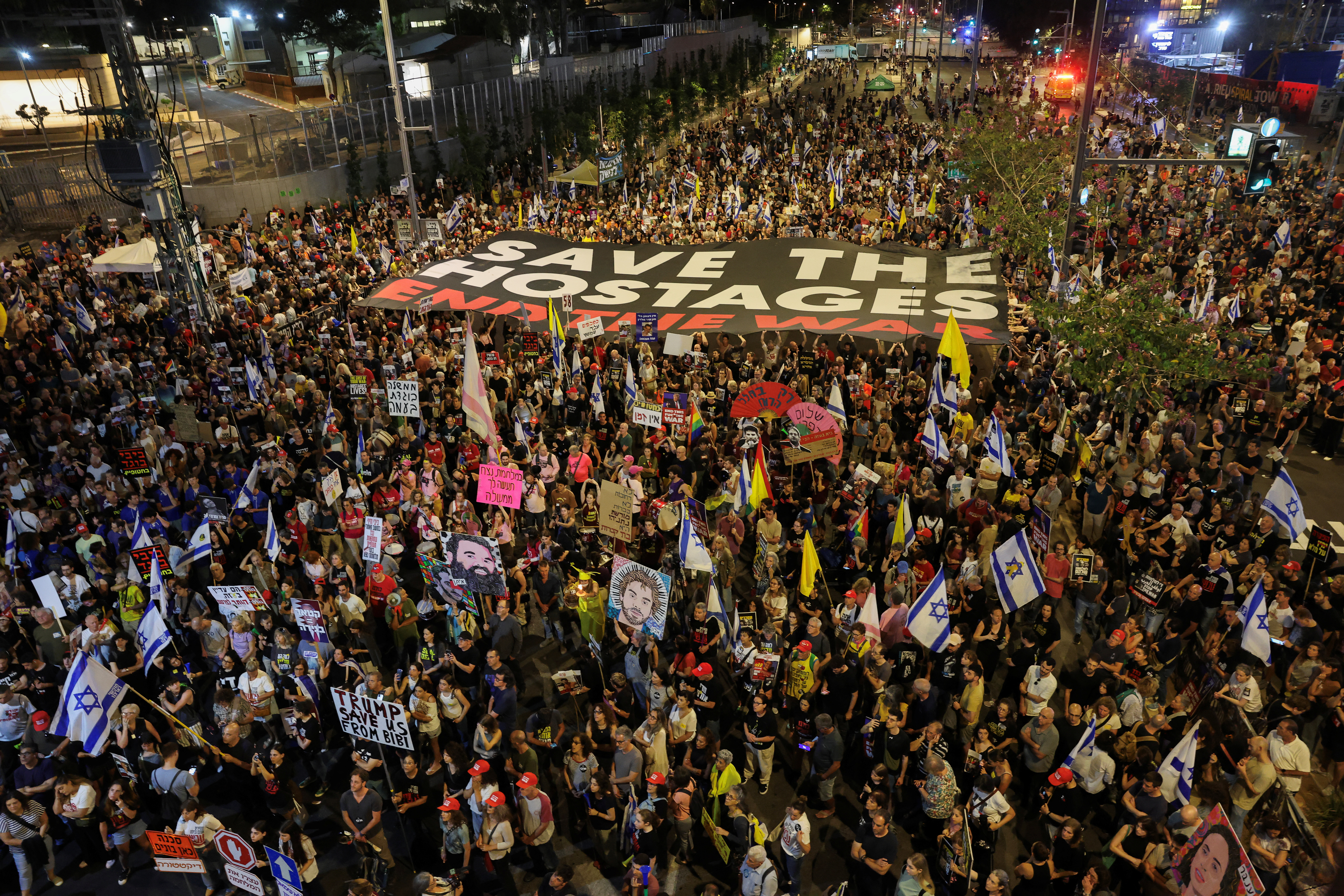 people hold a protest sign in a protest at night