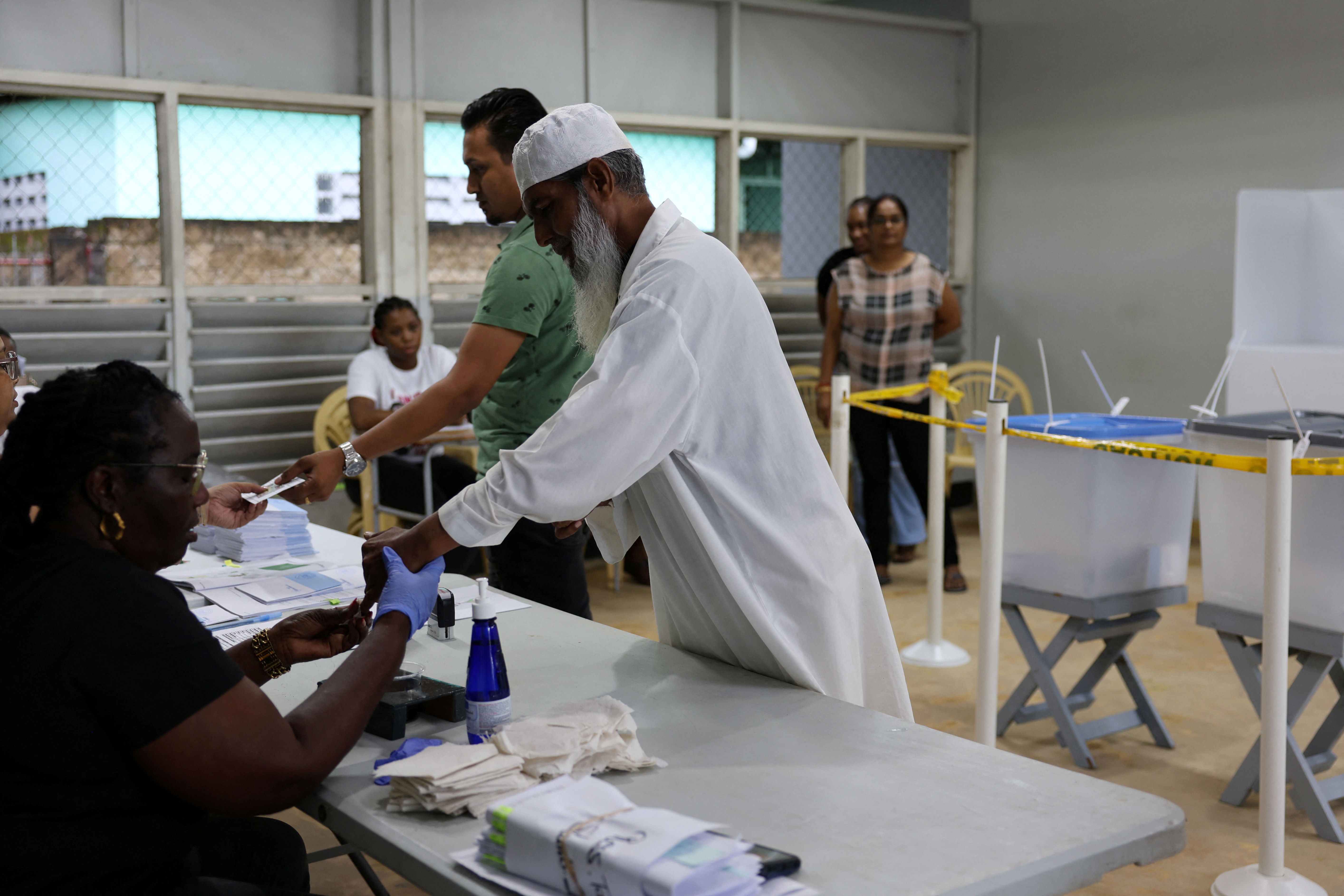 People vote at a polling station during the National Assembly election, in Paramaribo, Suriname, May 25, 2025. REUTERS/Ranu Abhelakh