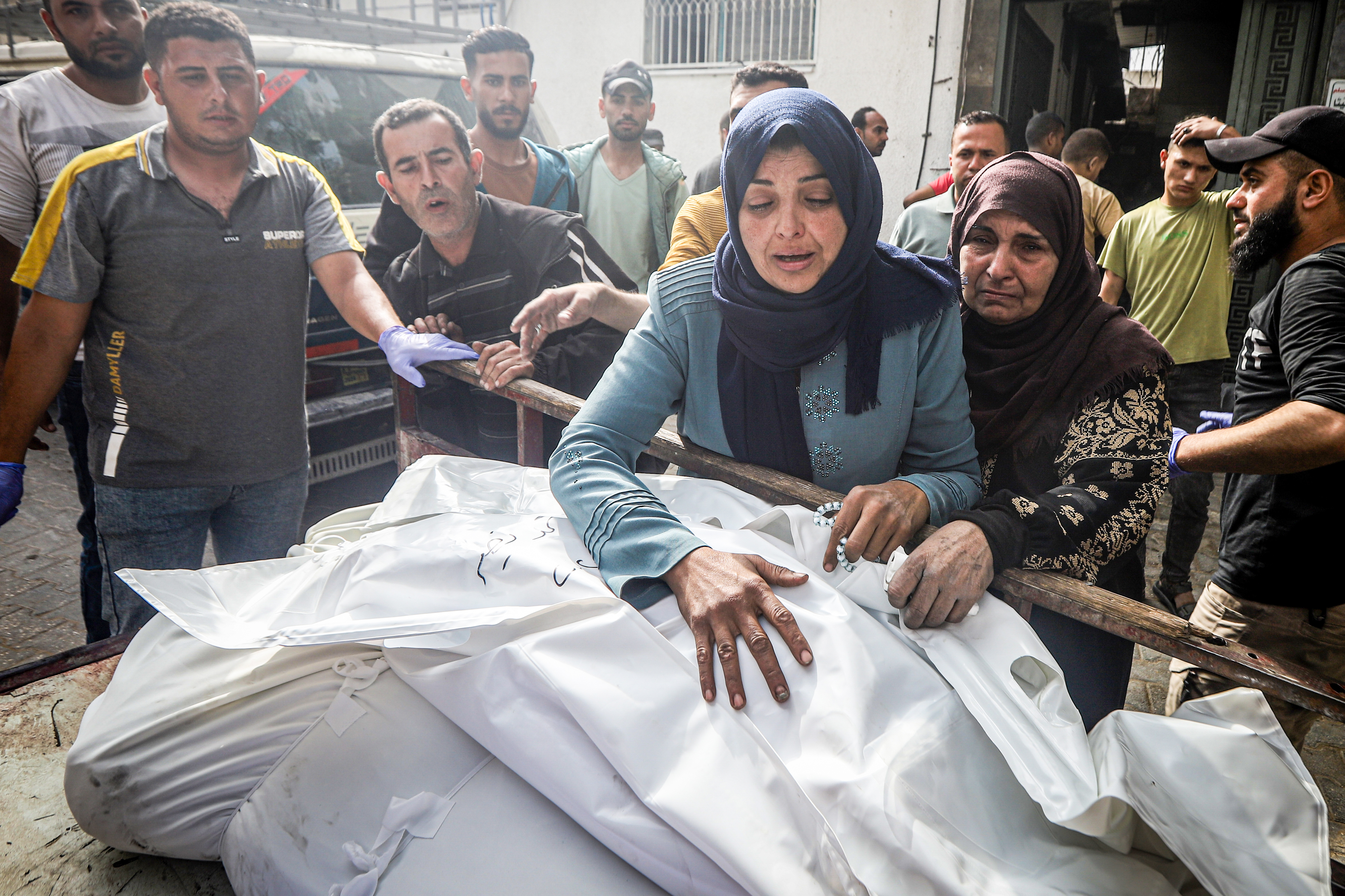 Relatives of the deceased mourn as the bodies of Palestinians killed