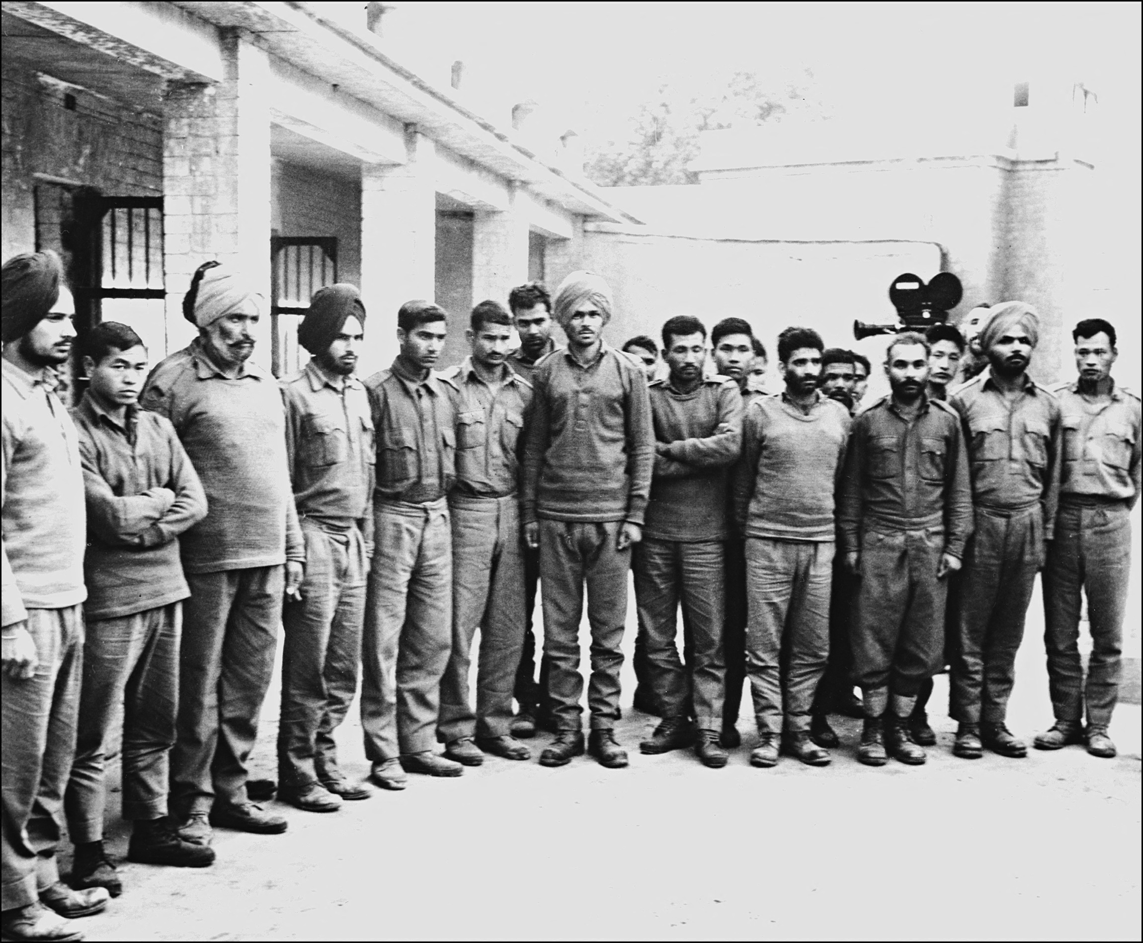 A group of Indian soldiers captured by Pakistani army pose for a photographer in a POW camp in December 1971 during the India-Pakistan border conflict.