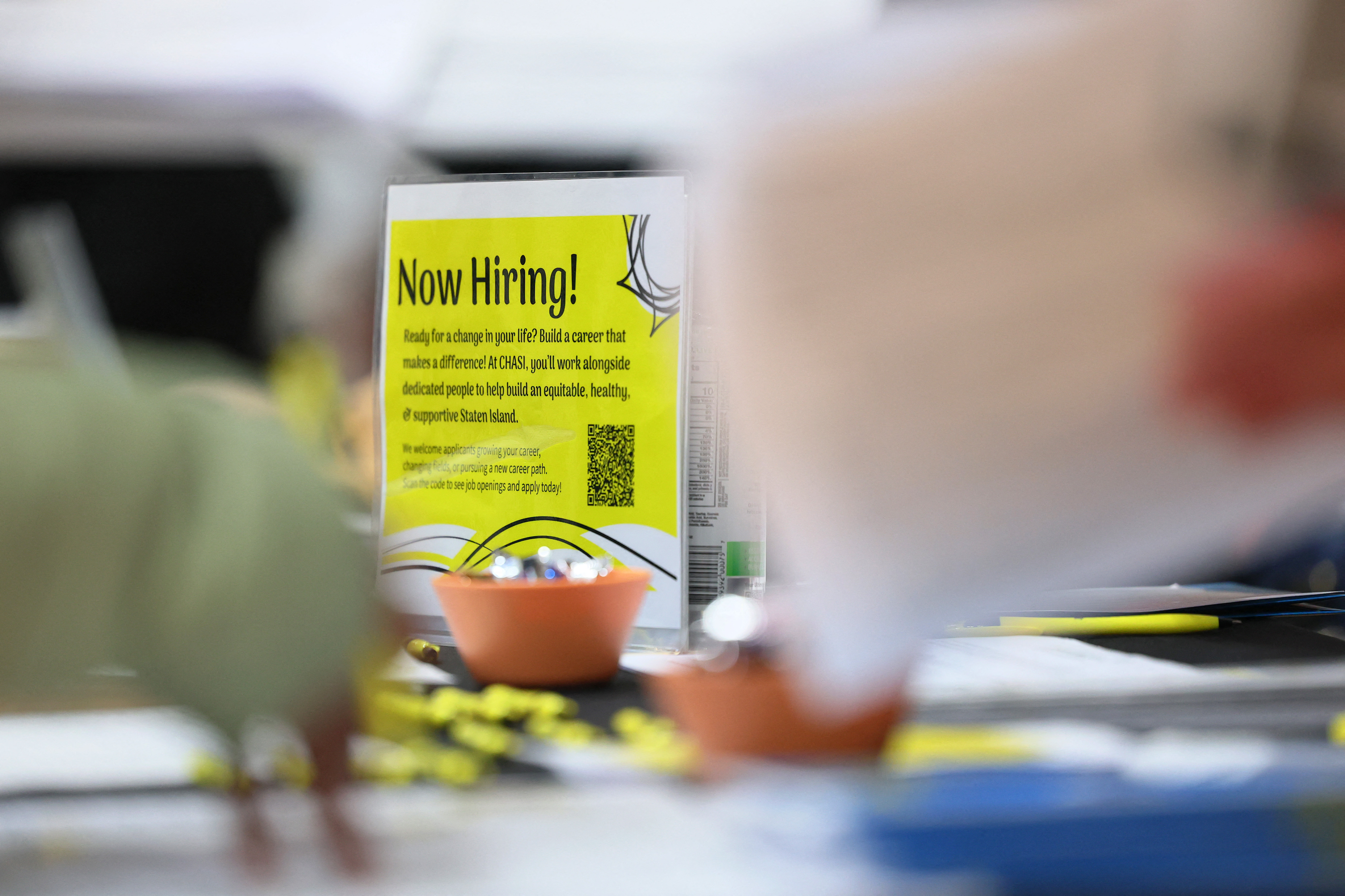 NEW YORK, NEW YORK - MARCH 27: A "Now Hiring" sign is seen during a job fair at the YMCA Gerard Carter Center on March 27, 2025 in the Stapleton Heights neighborhood of the Staten Island borough in New York City. Jobs NYC, a New York City initiative to help people find employment, held a job fair with various employers seeking workers. The Labor Department reported that U.S. employers added 151,000 jobs in February while the unemployment rate ticked up to 4.1%. Michael M. Santiago/Getty Images/AFP (Photo by Michael M. Santiago / GETTY IMAGES NORTH AMERICA / Getty Images via AFP)