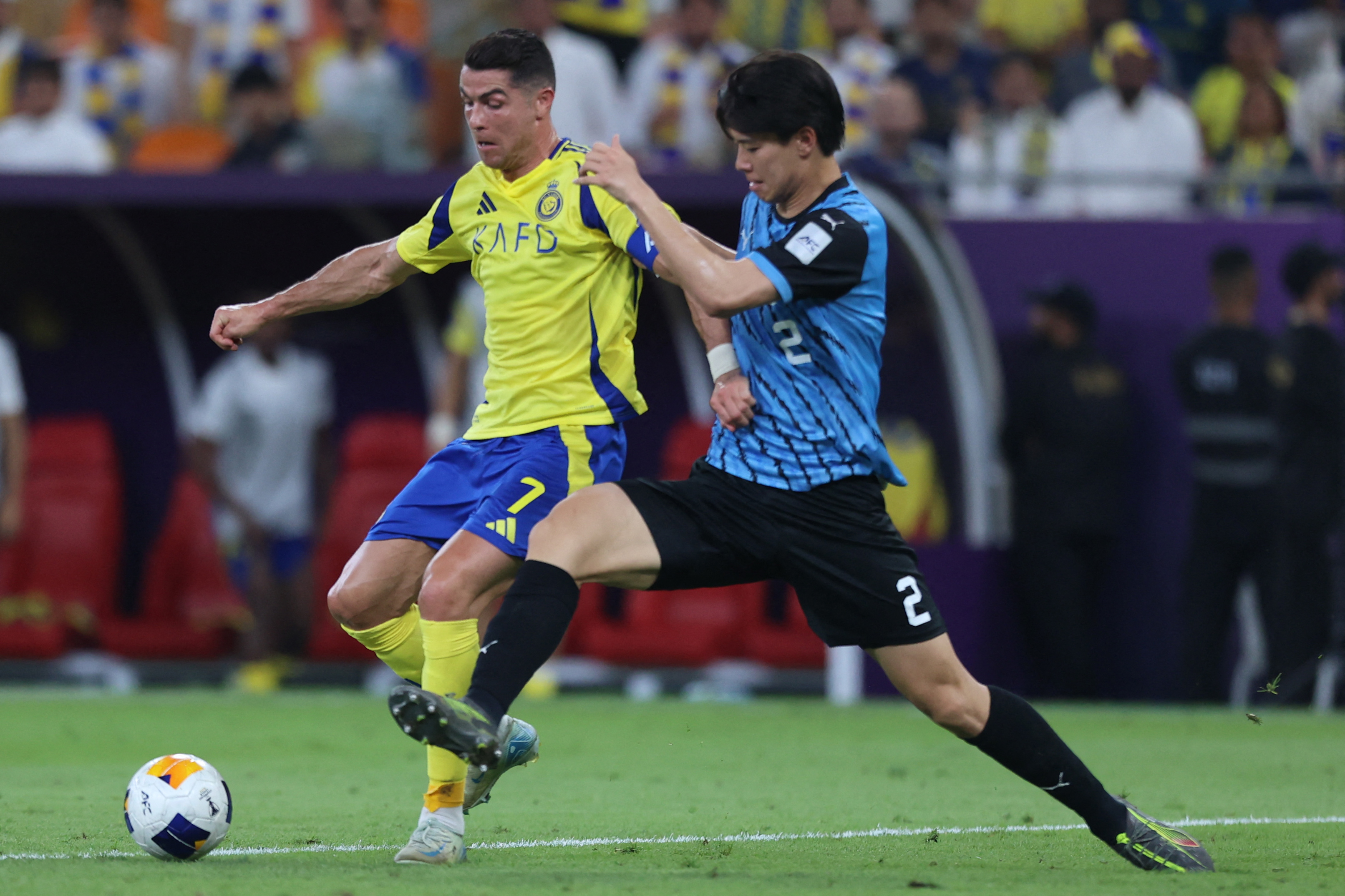 Nassr's Portuguese forward #7 Cristiano Ronaldo fights for the ball with Kawasaki's Japanese defender #2 Kota Takai during the AFC Champions League semi-final match between Saudi's Al-Nassr and Japan's Kawasaki at King Abdullah Sports City in Jeddah on April 30, 2025. (Photo by AFP)