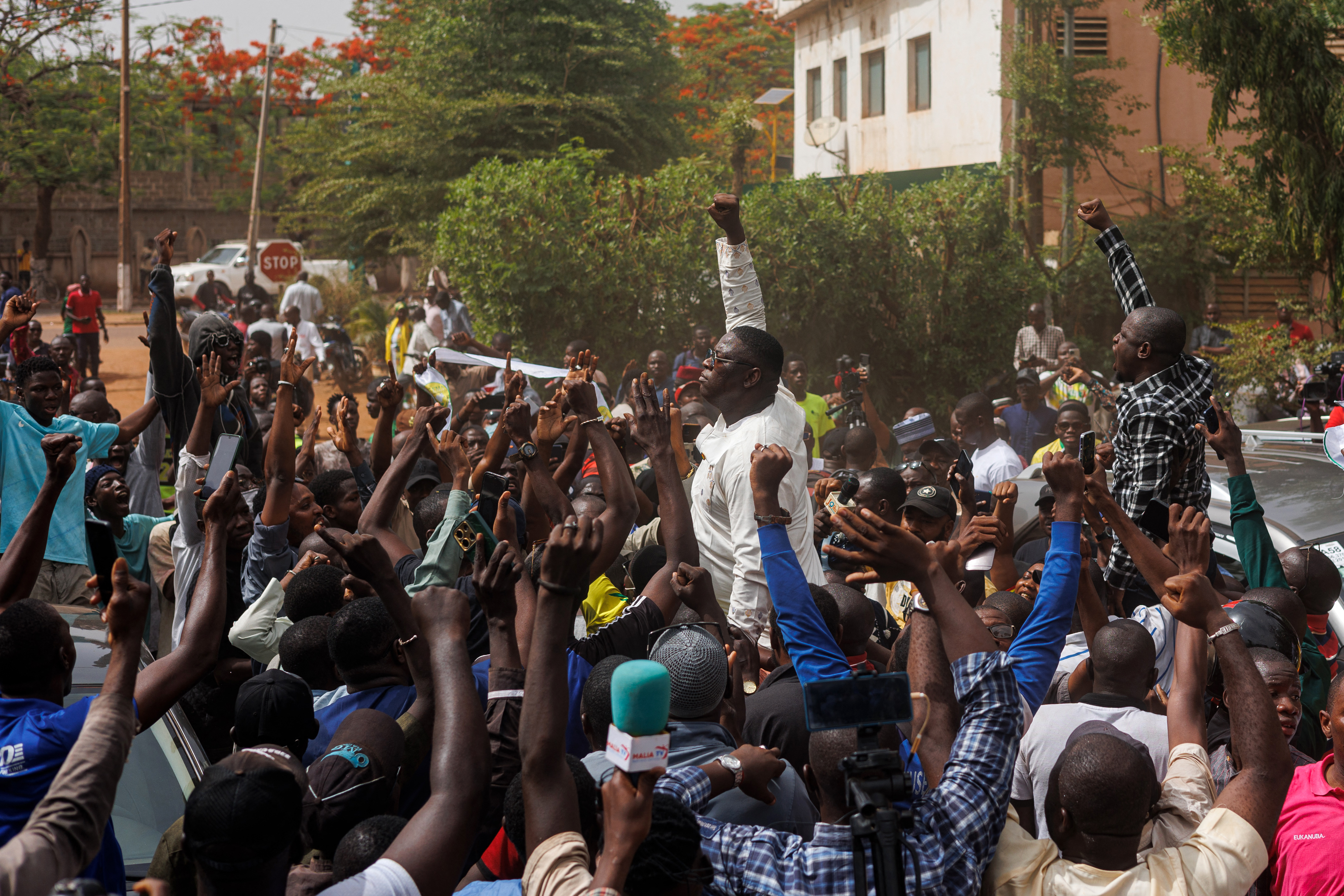 Pro-democracy youth leader Cheick Oumar Diarra (C) chants slogans surrounded by supporters during a protest.