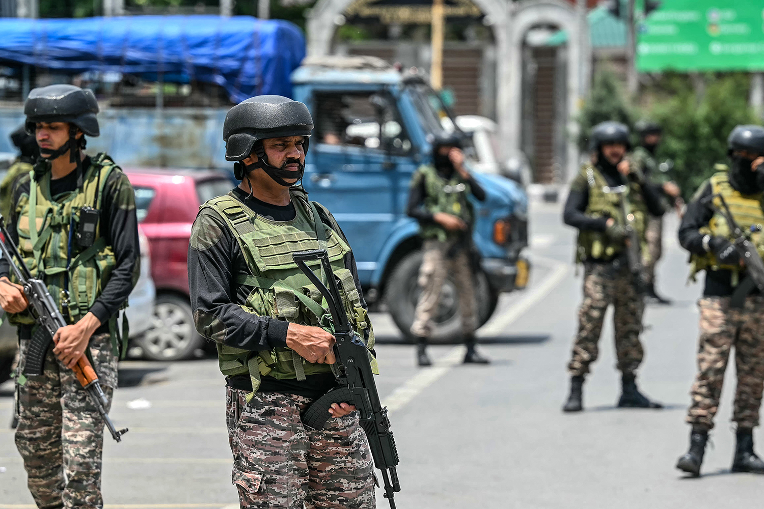 Indian paramilitary soldiers stand guard along a street in Srinagar