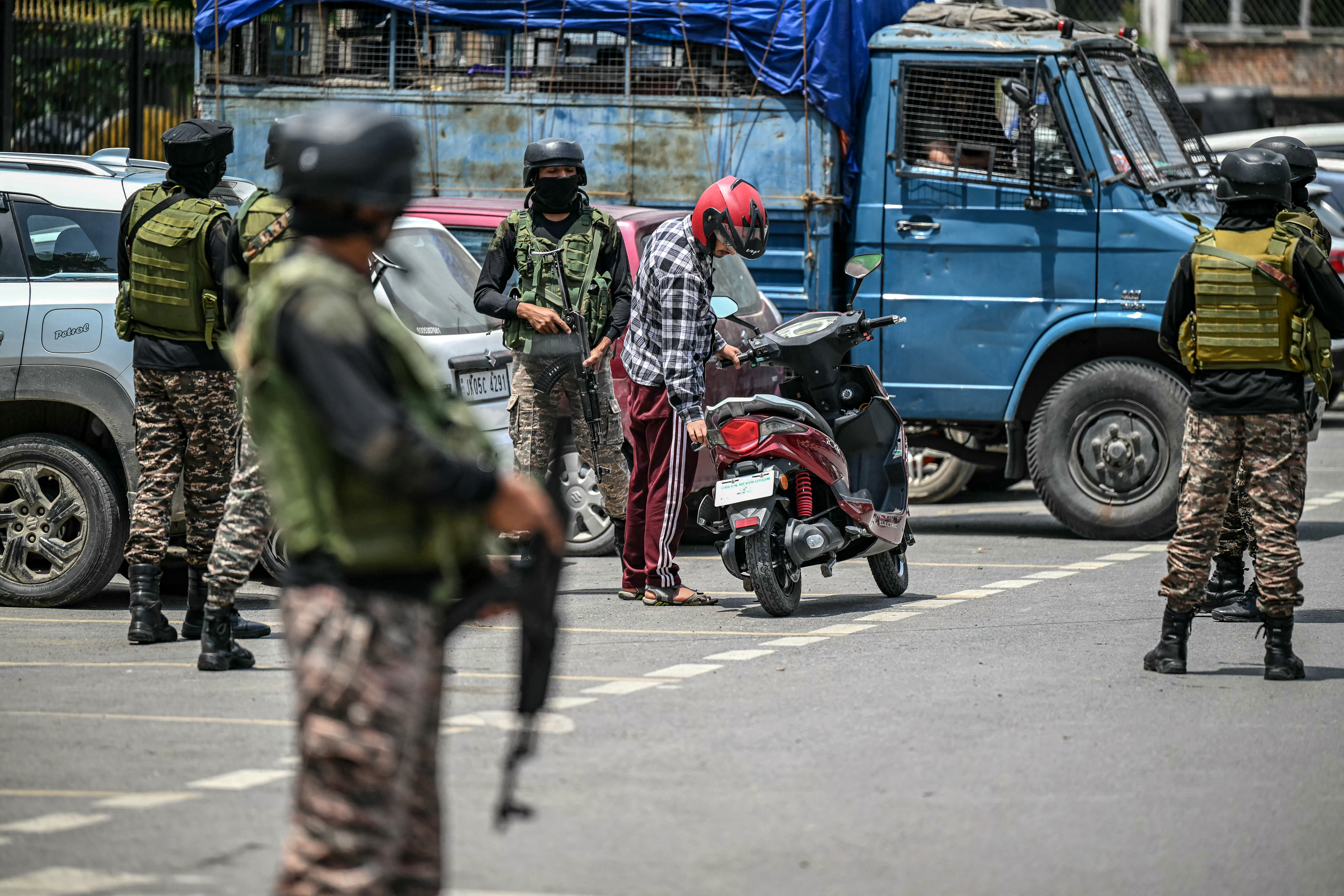 ndian paramilitary soldiers inspect a resident in Srinagar on May 11, 2025.