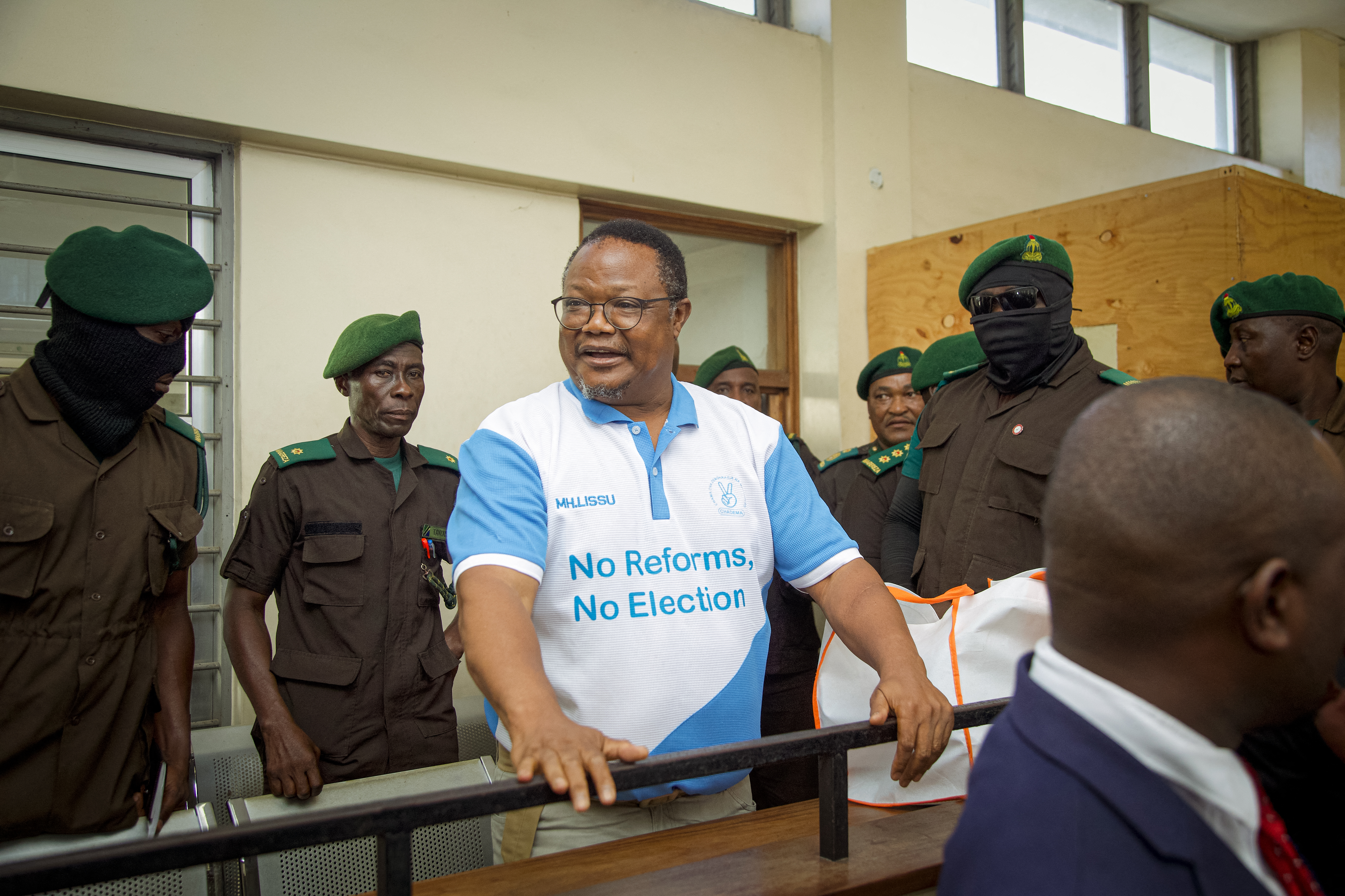 Tanzania's main opposition leader Tundu Lissu (C) stands in the dock at Kisutu magistrate's court in Dar es Salaam on May 19, 2025.