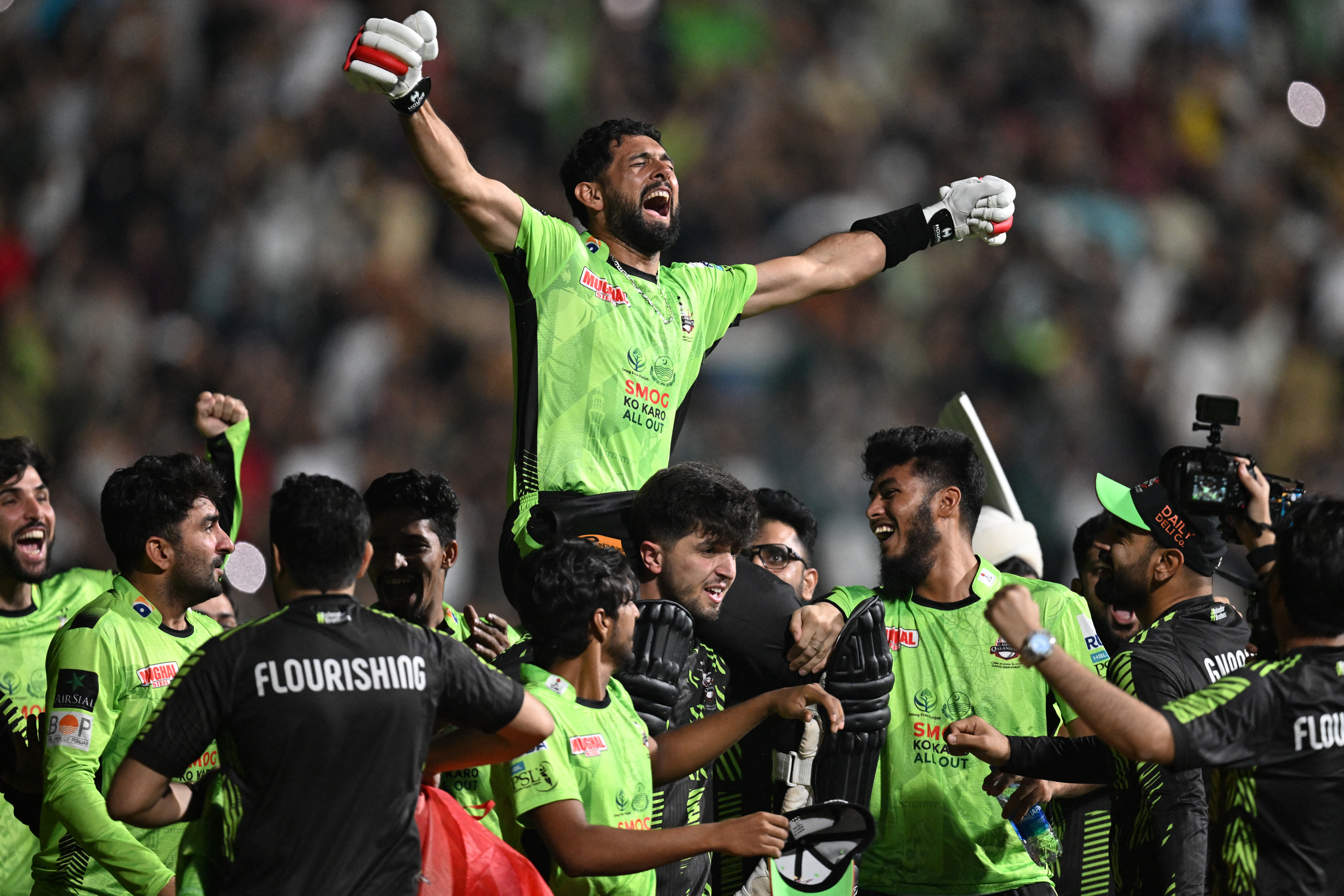 Lahore Qalanders' players carry teammate Sikandar Raza as they celebrate after their victory in the Pakistan Super League (PSL) Twenty20 final cricket match between Lahore Qalandars and Quetta Gladiators at the Gaddafi Stadium in Lahore on May 25, 2025. (Photo by Aamir QURESHI / AFP)
