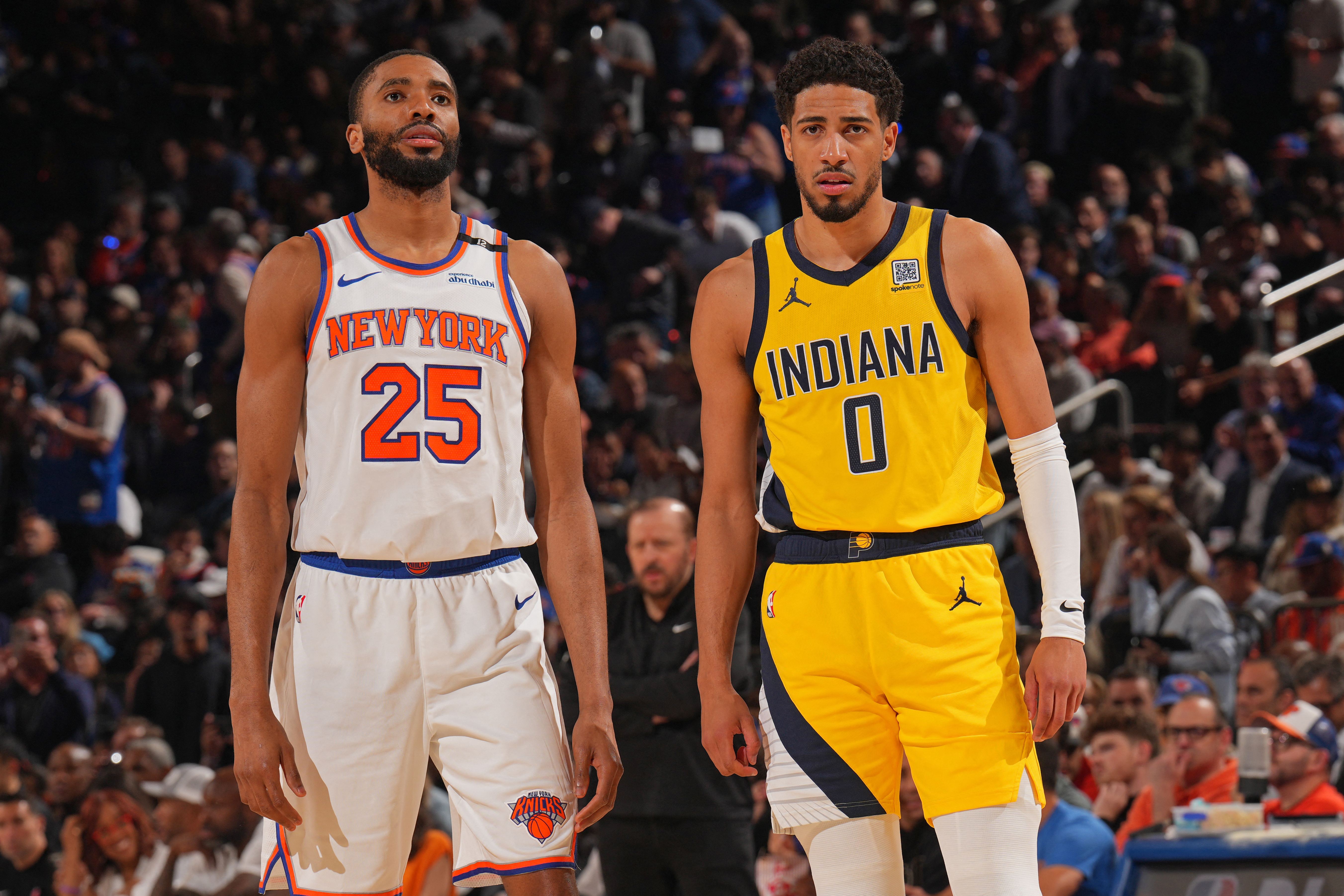 Mikal Bridges #25 of the New York Knicks and Tyrese Haliburton #0 of the Indiana Pacers look on.