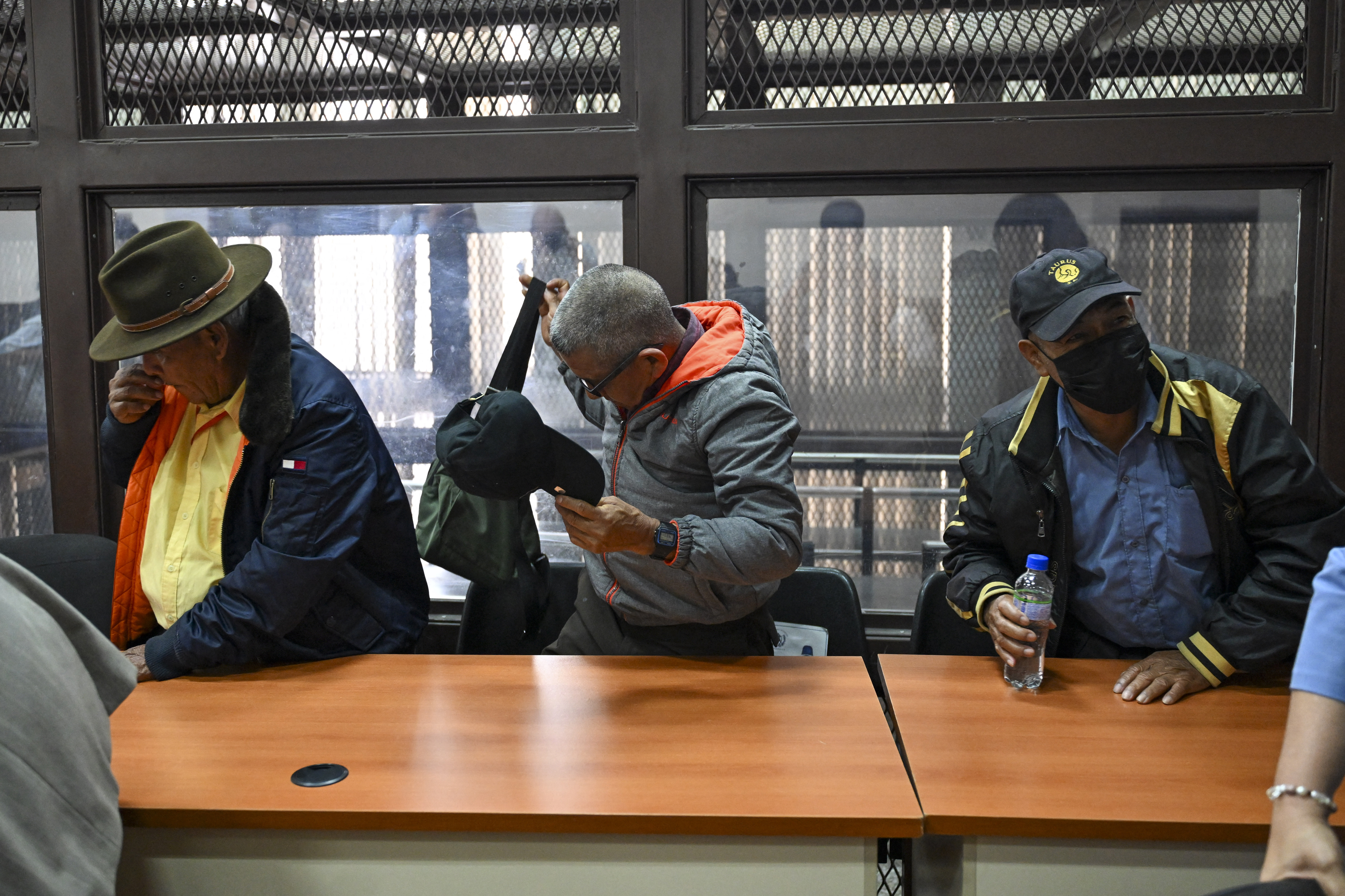EDITORS NOTE: Graphic content / Former paramilitaries Simeon Enriquez (L), Pedro Sanchez (C), and Felix Tum react after being sentenced to 40 years in prison for crimes of sexual violence against six Mayan women from the Achi community of Rabinal during the civil war in Guatemala (1960-1996), at the courtroom in Guatemala City on May 30, 2025. The three former paramilitaries, also indigenous, were members of the Civil Self-Defense Patrols, created by the Armed Forces to fight the leftist guerrillas during the war that left 200,000 dead and missing, according to the UN. (Photo by JOHAN ORDONEZ / AFP)