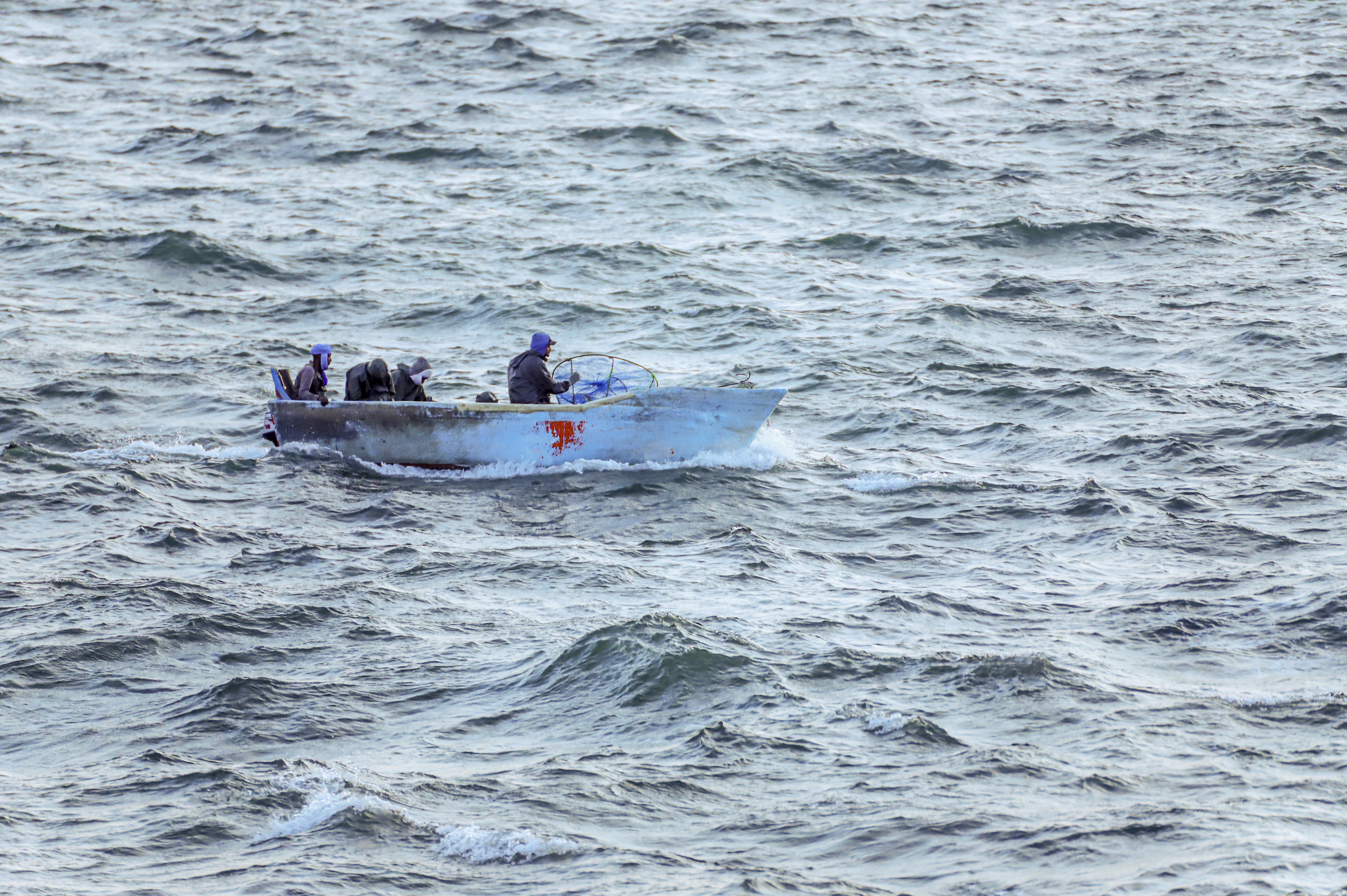 Fishermen at sea in a boat.