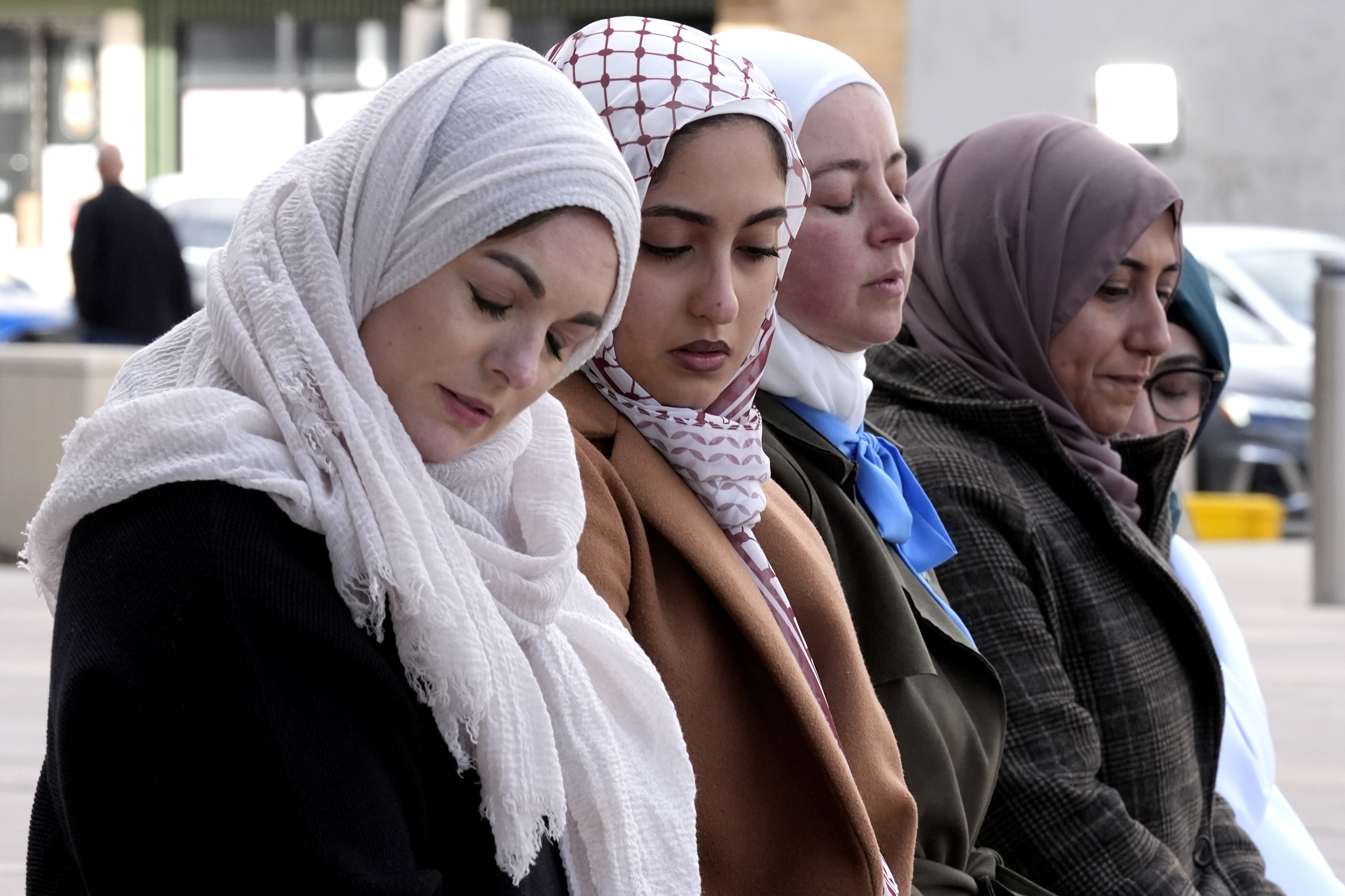 A group of women attend an outdoor prayer vigil for Wadea AlFayoumi