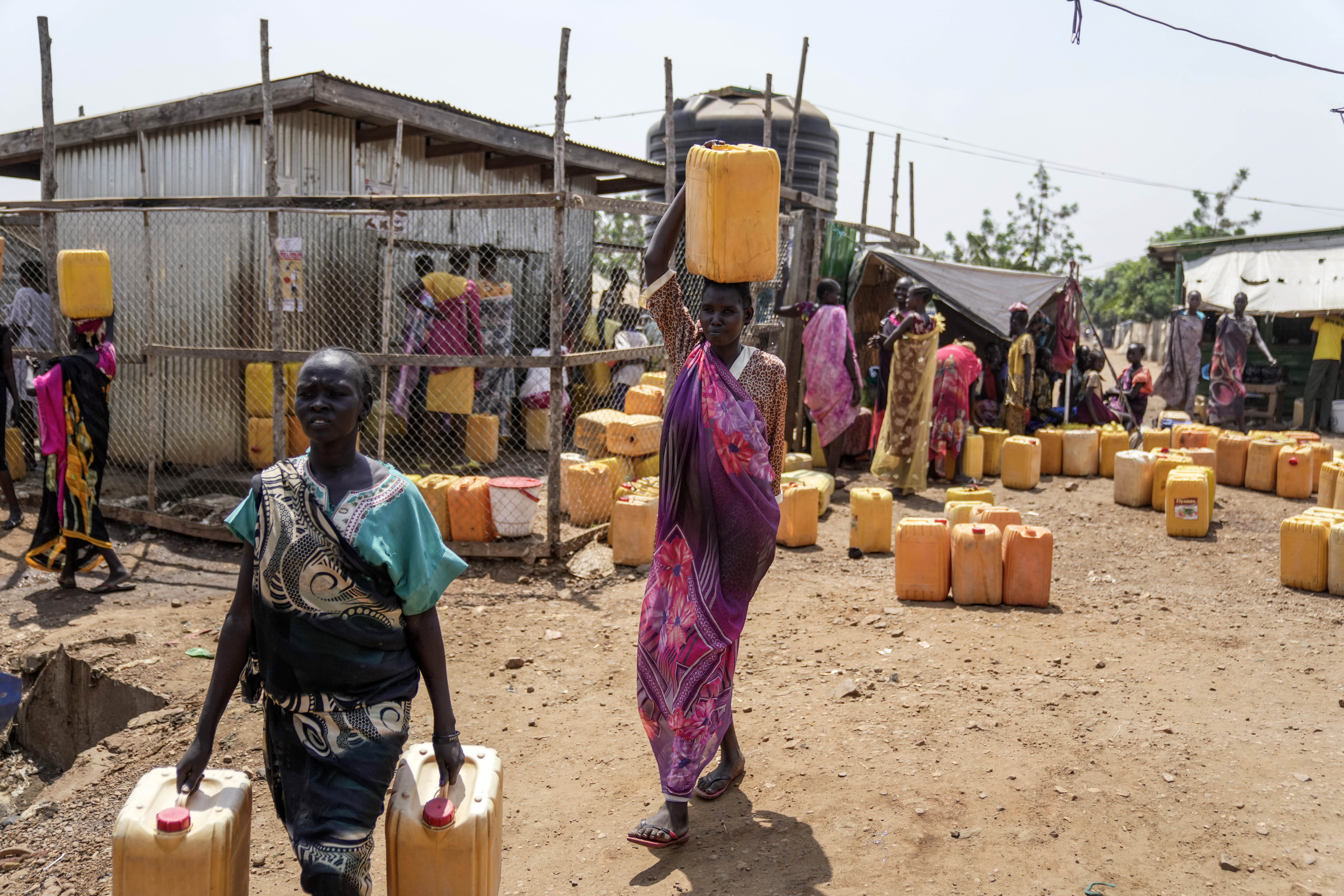 Internally displaced people fetch water inside a camp on the outskirts of Juba, South Sudan