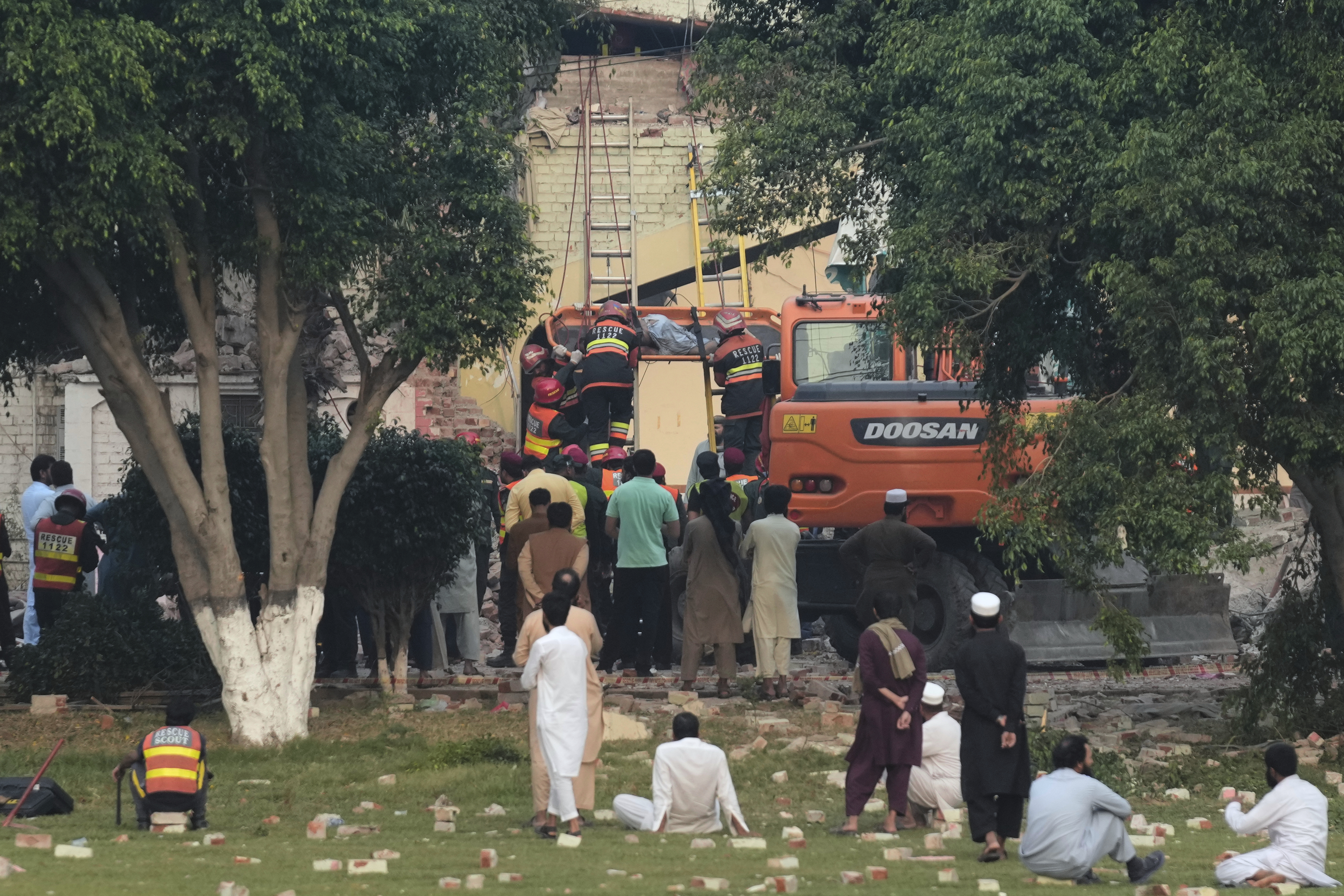 Rescue workers recover a body from a damaged building at the site of a suspected Indian missile attack, in Muridke, a town in Pakistan's Punjab province, Wednesday, May 7, 2025. (AP Photo/K.M. Chaudary)
