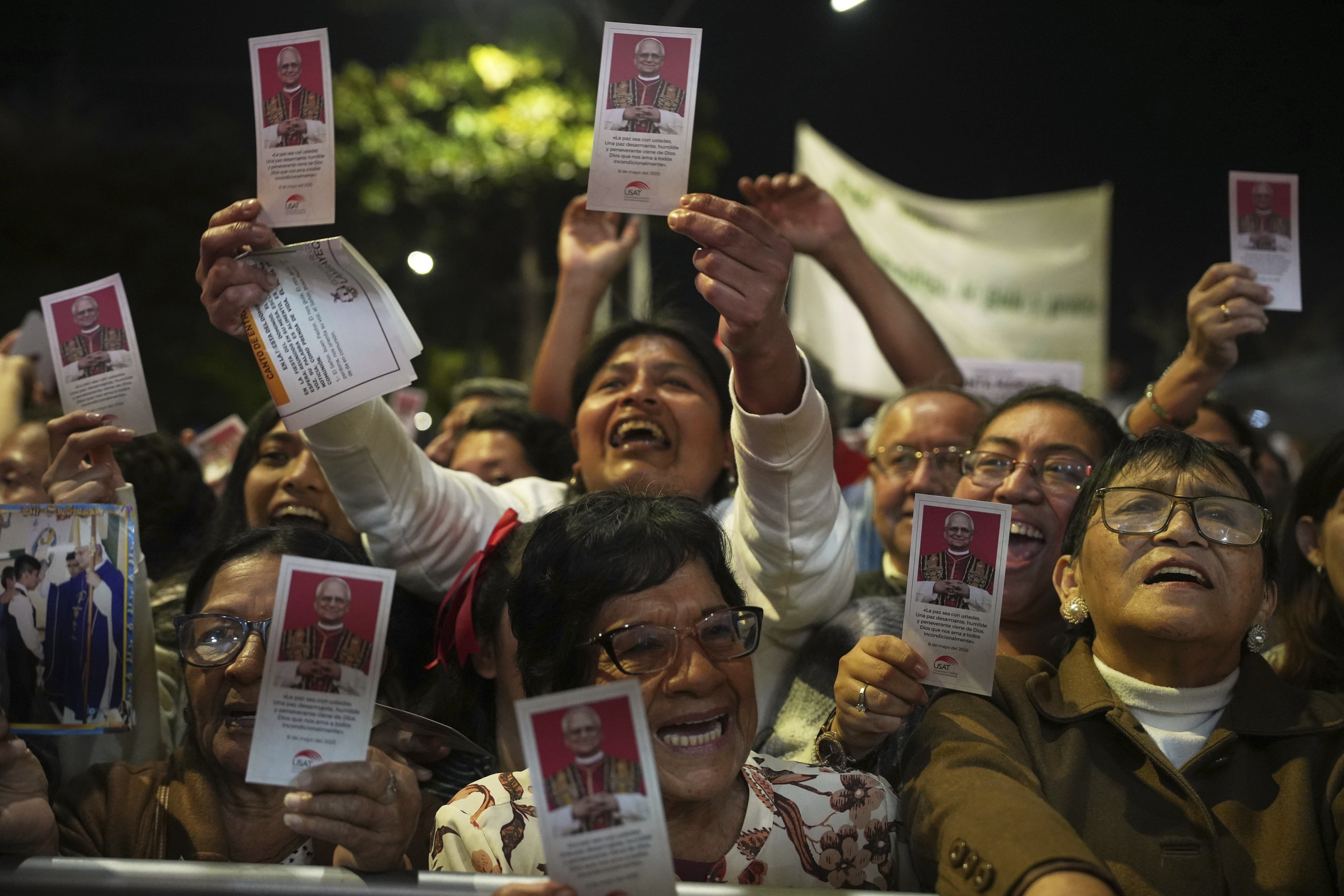 Peruvians hold up photos of Pope Leo XIV
