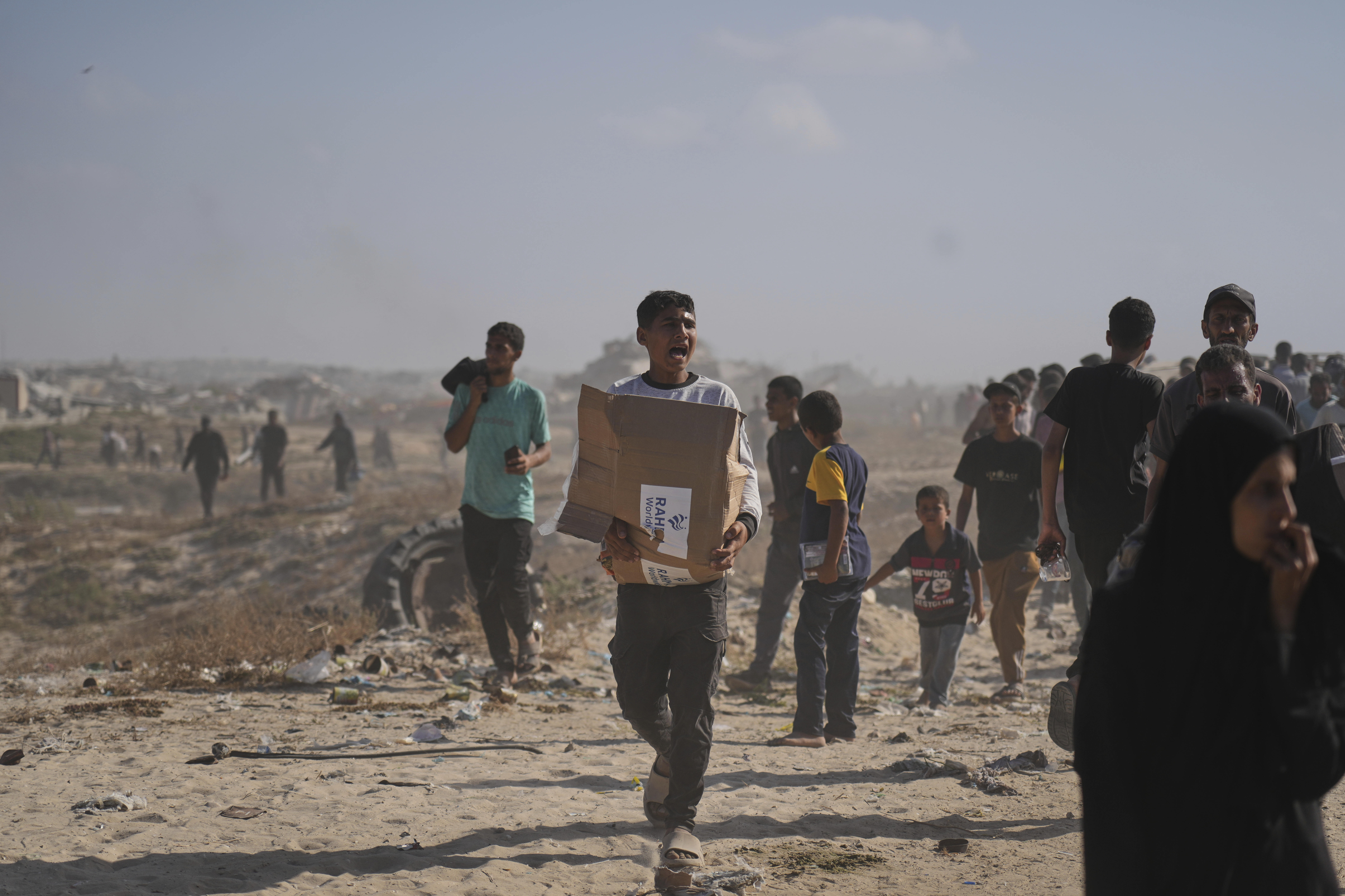 Palestinians carry boxes containing food and humanitarian aid packages delivered by the Gaza Humanitarian Foundation, a U.S.-backed organization approved by Israel, in Rafah, southern Gaza Strip, on Tuesday, May 27, 2025.
