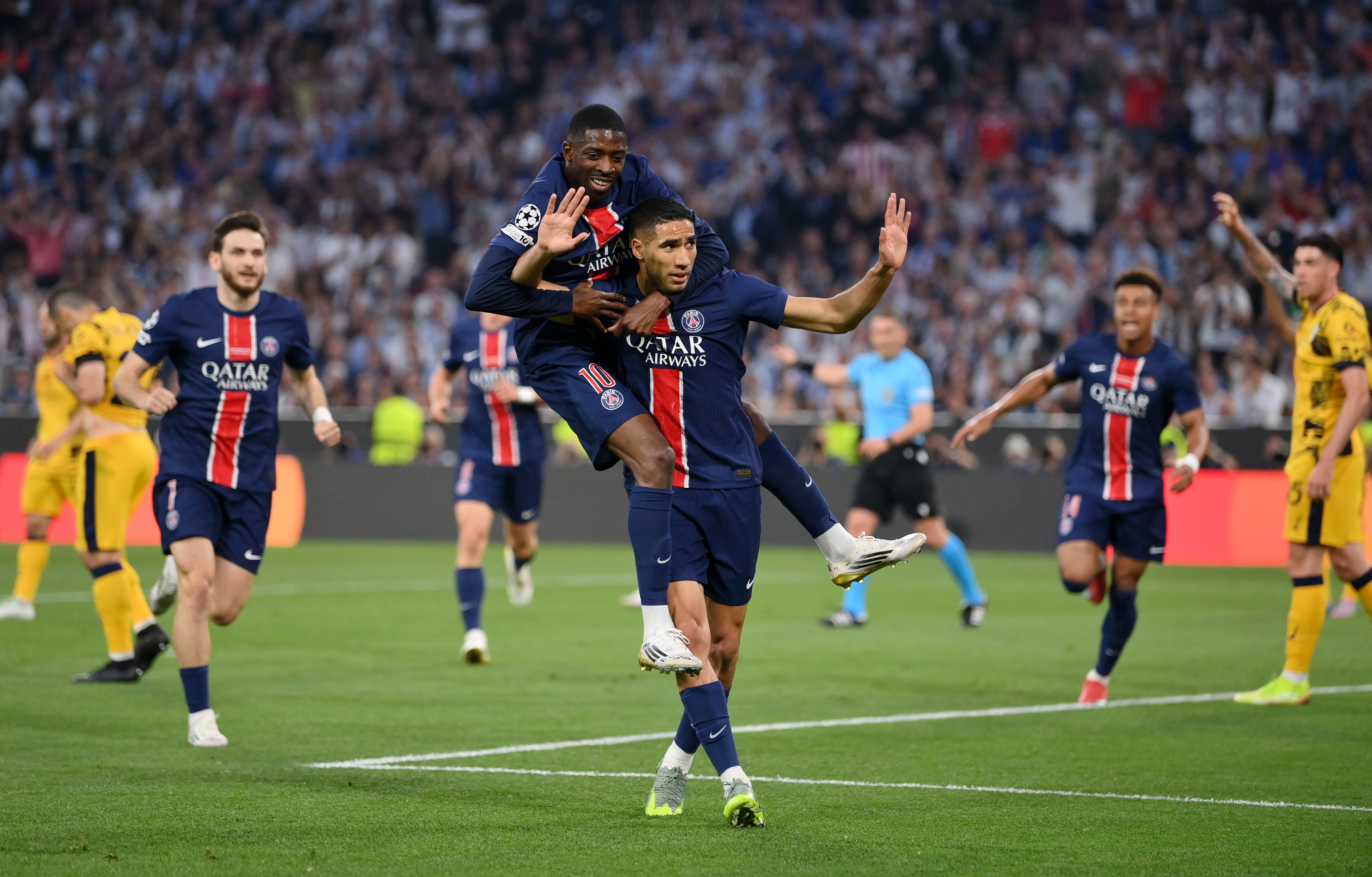Achraf Hakimi of Paris Saint-Germain celebrates scoring his team's first goal with teammate Ousmane Dembele during the UEFA Champions League Final