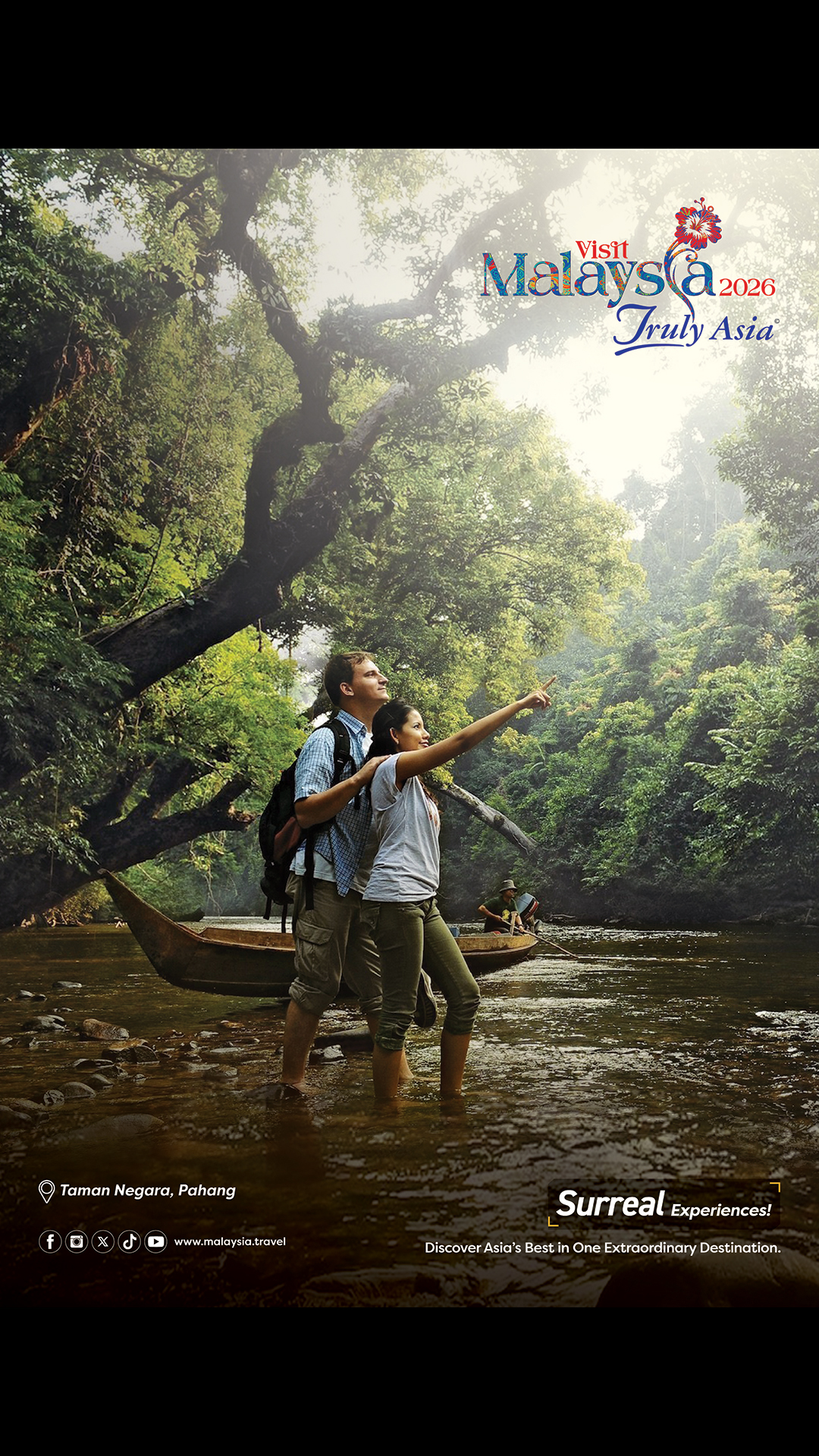 Two people stand in a river surrounded by jungle