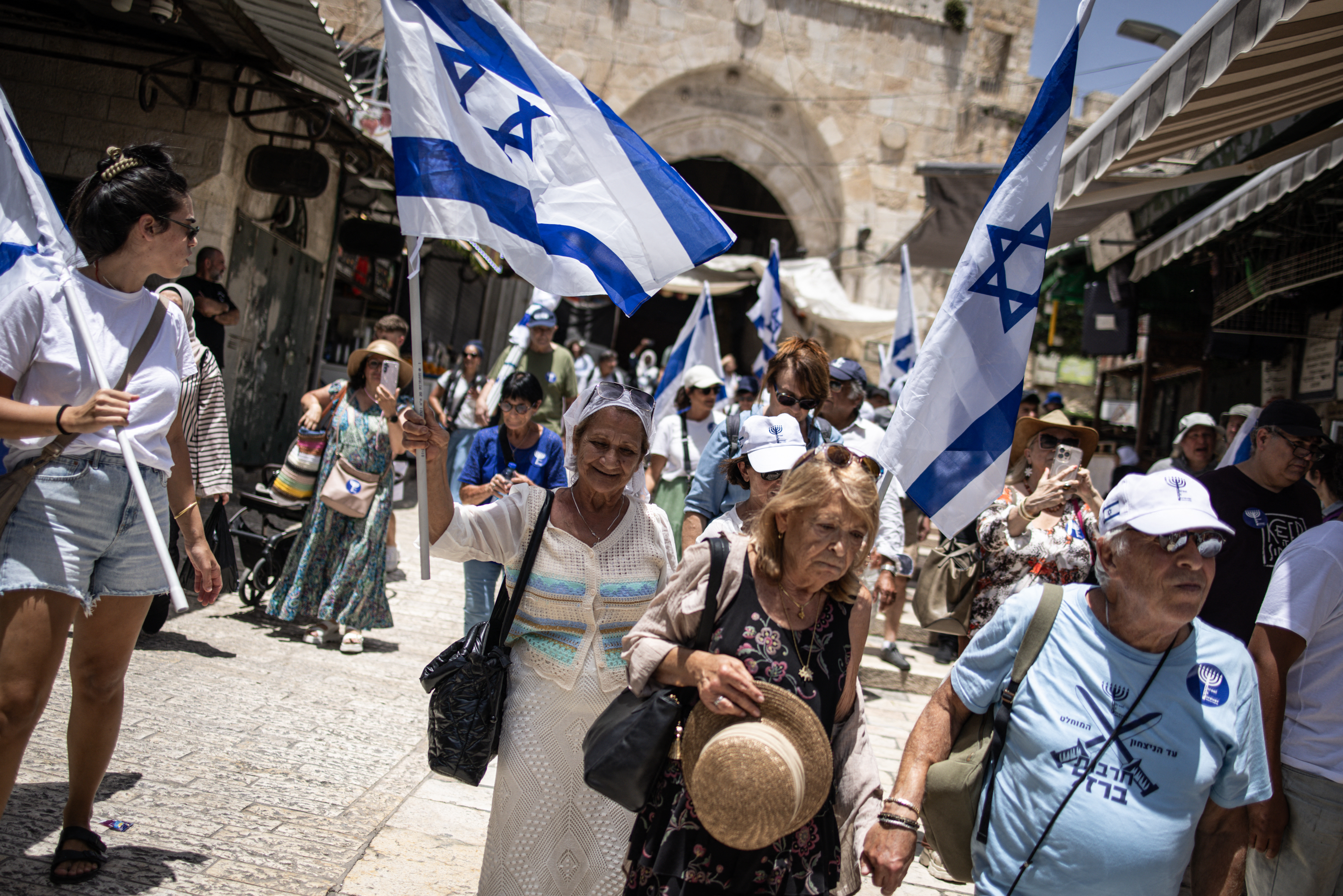 Israeli right-wing activists carry national flags in Jerusalem's Old City during a flag march for Jerusalem Day on May 26, 2025, commemorating the Israeli army's 1967 capture of the city's eastern sector during the Arab-Israeli war.