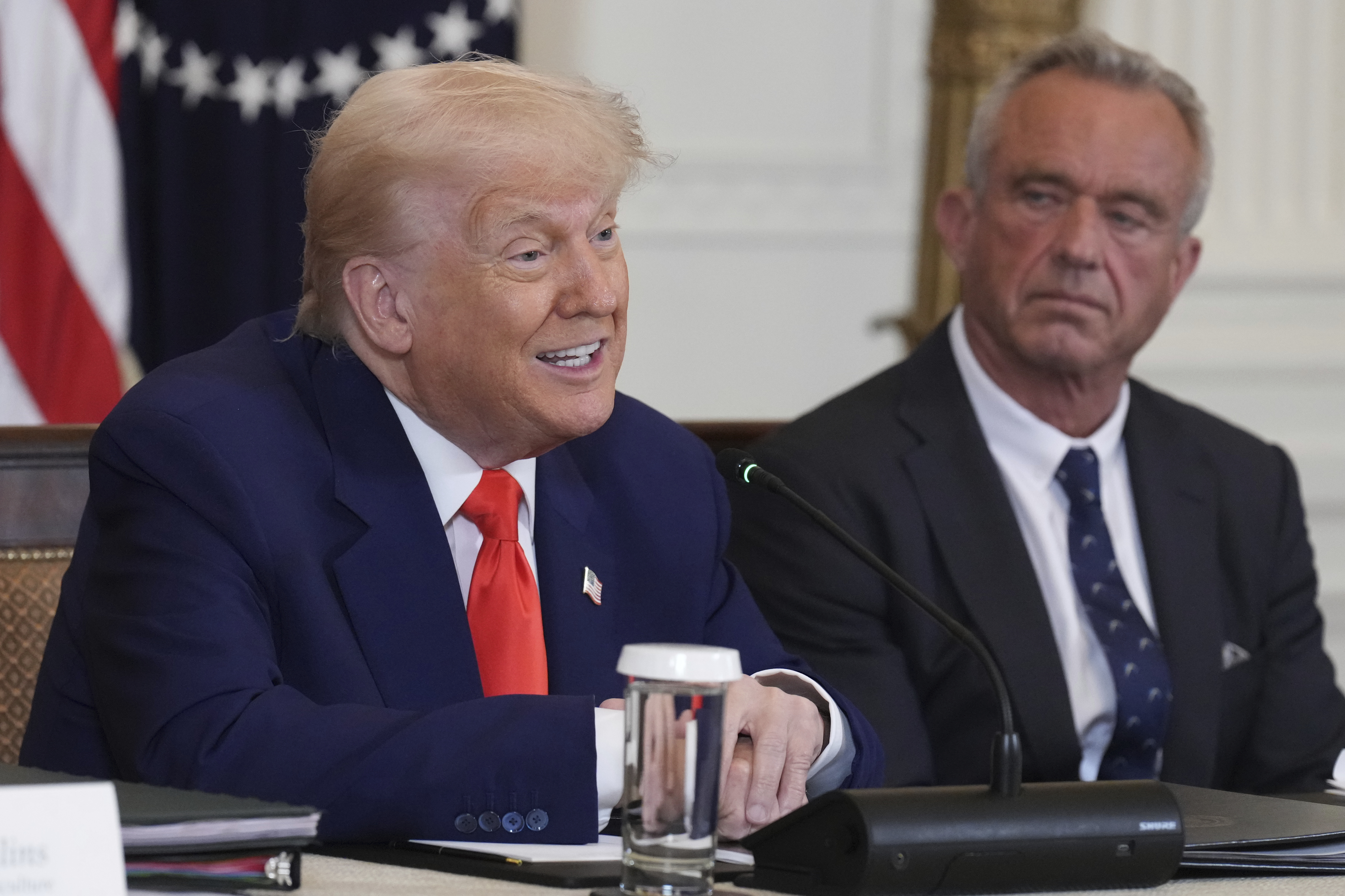 President Donald Trump, left, speaks as Health and Human Services Secretary Robert F. Kennedy Jr. listens during a Make America Healthy Again (MAHA) Commission Event in the East Room of the White House, Thursday, May 22, 2025, in Washington. (AP Photo/Jacquelyn Martin)