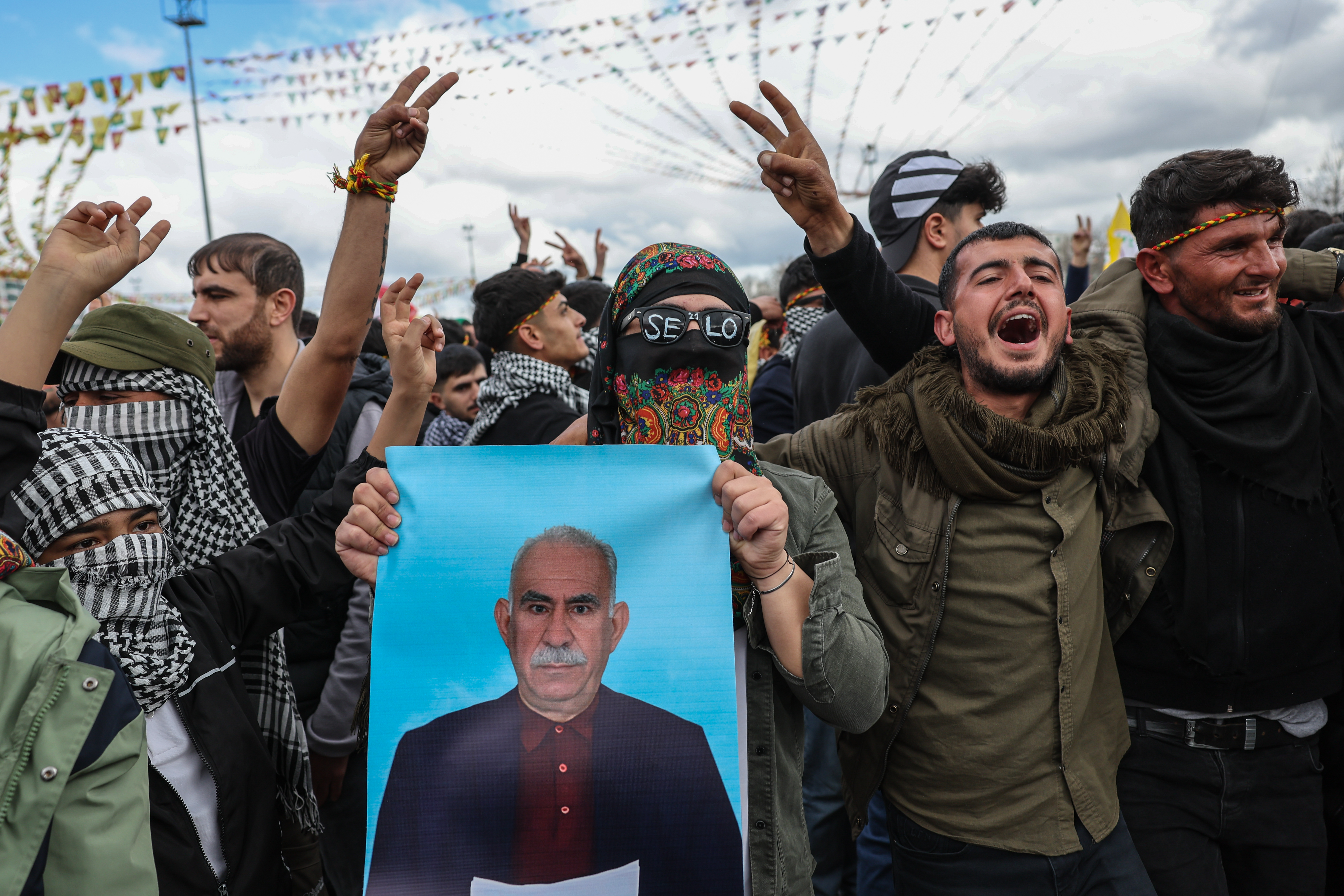 DIYARBAKIR, TURKEY - MARCH 21: Masked Kurdish youths holds a poster of jailed PKK militant group leader Abdullah Ocalan during Newroz celebrations on March 21, 2025 in Diyarbakir, Turkey. Newroz, or Nowruz, a celebration of the spring equinox and Persian new year, is observed by a diverse array of communities across western and central Asia, including Kurdish areas of Turkey, Syria and Iraq. Newroz is the most important festival in Kurdish culture and has taken the form of political expression among Kurds in Turkey. (Photo by Sedat Suna/Getty Images)