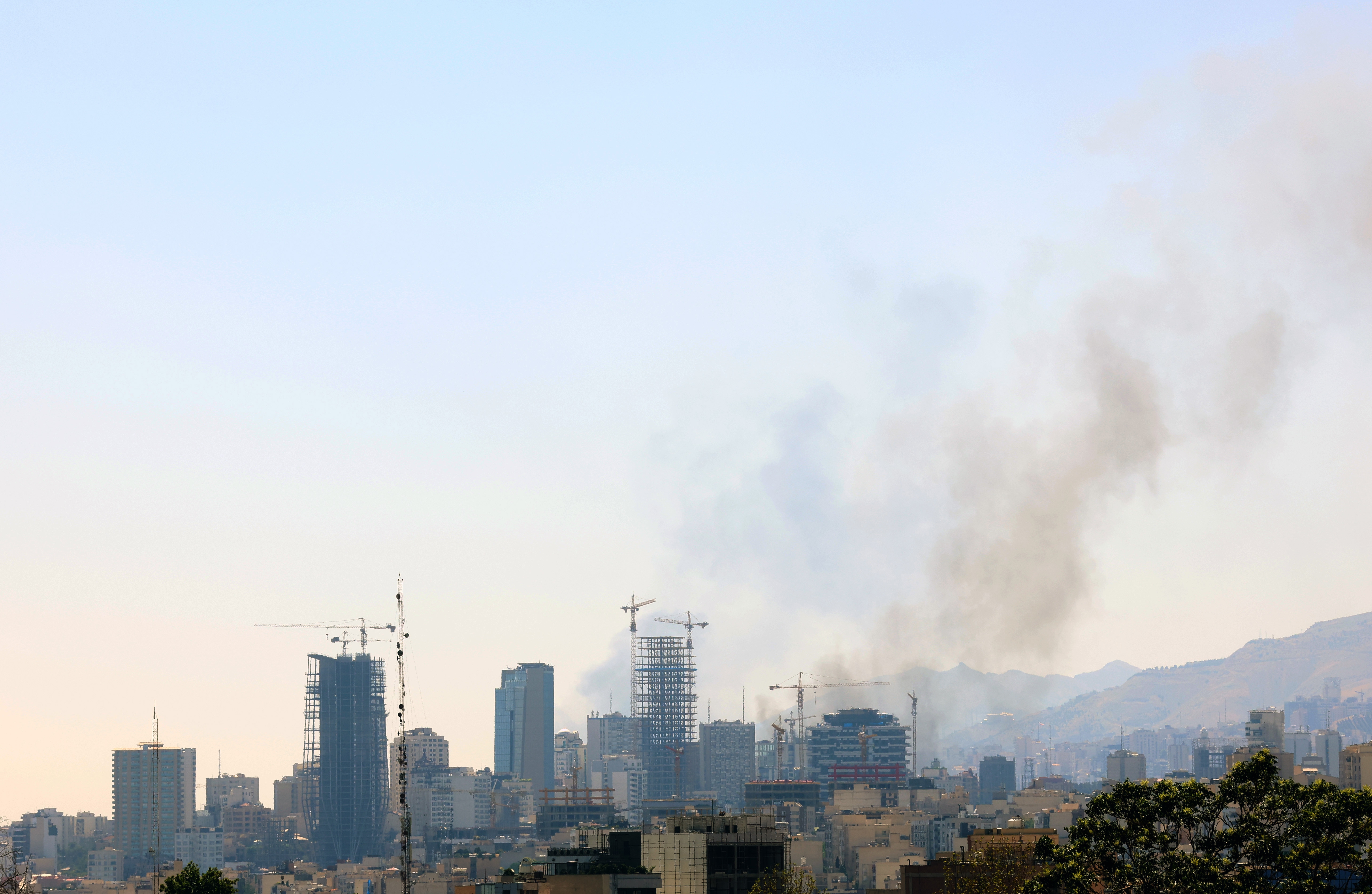 epa12180804 Smoke rises after an Israel airstrike in central Tehran, Iran, 17 June 2025. Israel has been conducting strikes across Iran since 13 June, targeting nuclear, military, and energy facilities, prompting Iran to launch retaliatory waves of missiles and drones toward Israel. EPA-EFE/ABEDIN TAHERKENAREH