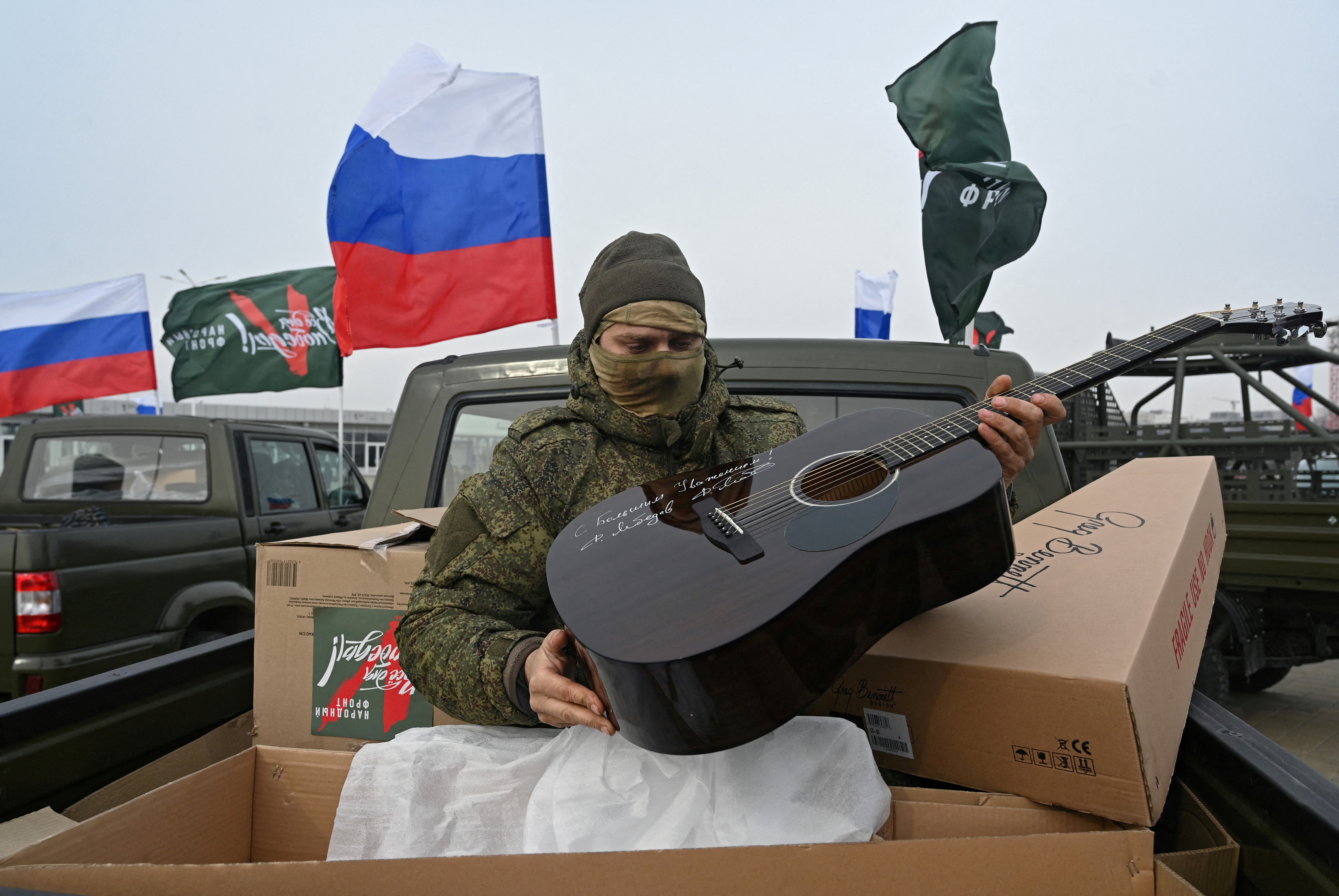 A Russian service member unpacks a guitar during a ceremony to receive new vehicles and military equipment handed over by the Russian movement "People's Front" for the military involved in Russia-Ukraine conflict, in Rostov-on-Don, Russia February 23, 2025. REUTERS/Stringer TPX IMAGES OF THE DAY