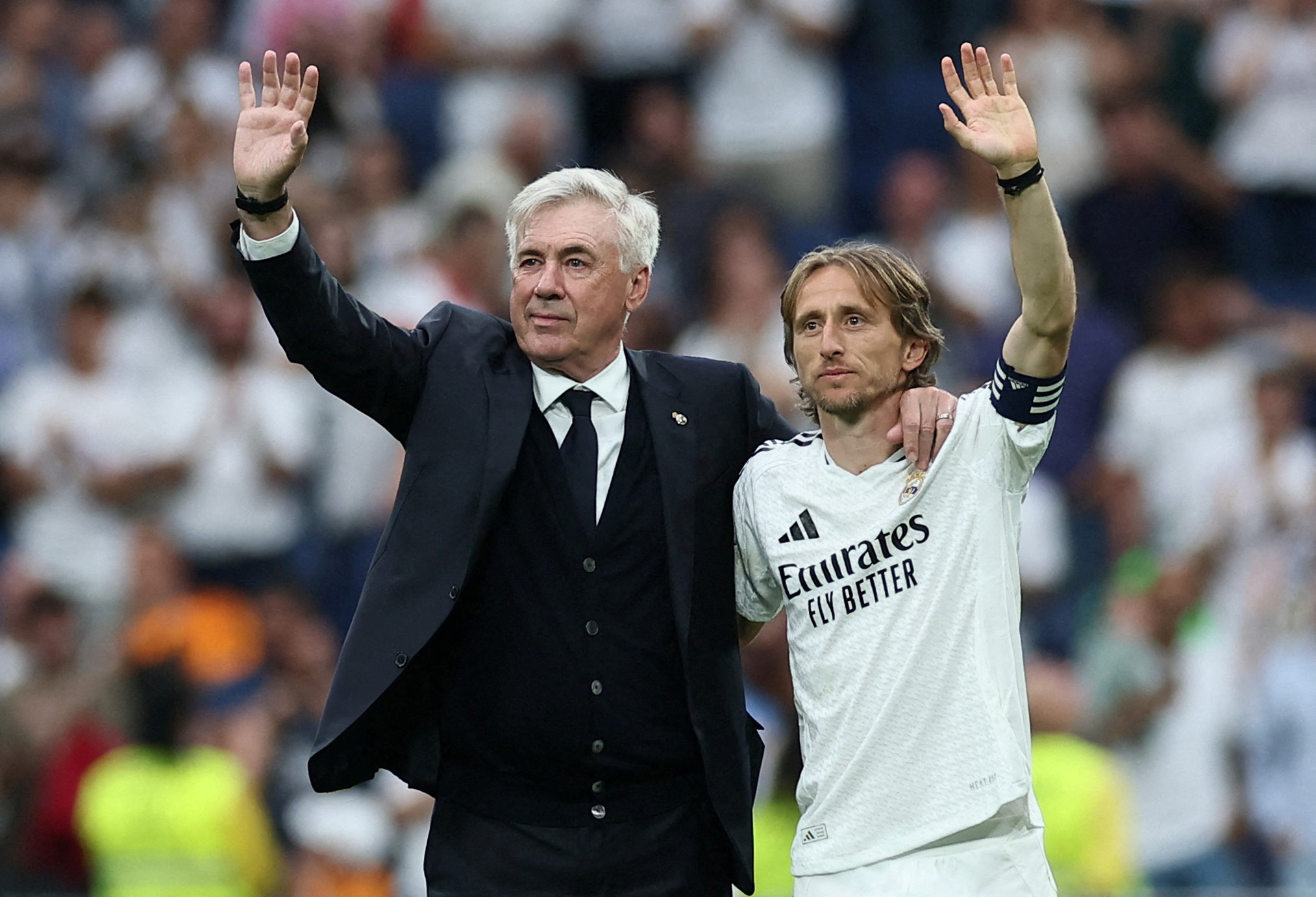 Real Madrid coach Carlo Ancelotti acknowledges fans on the pitch after his last match as Real Madrid coach and Real Madrid's Luka Modric reacts after he played his last LaLiga match for Real Madrid