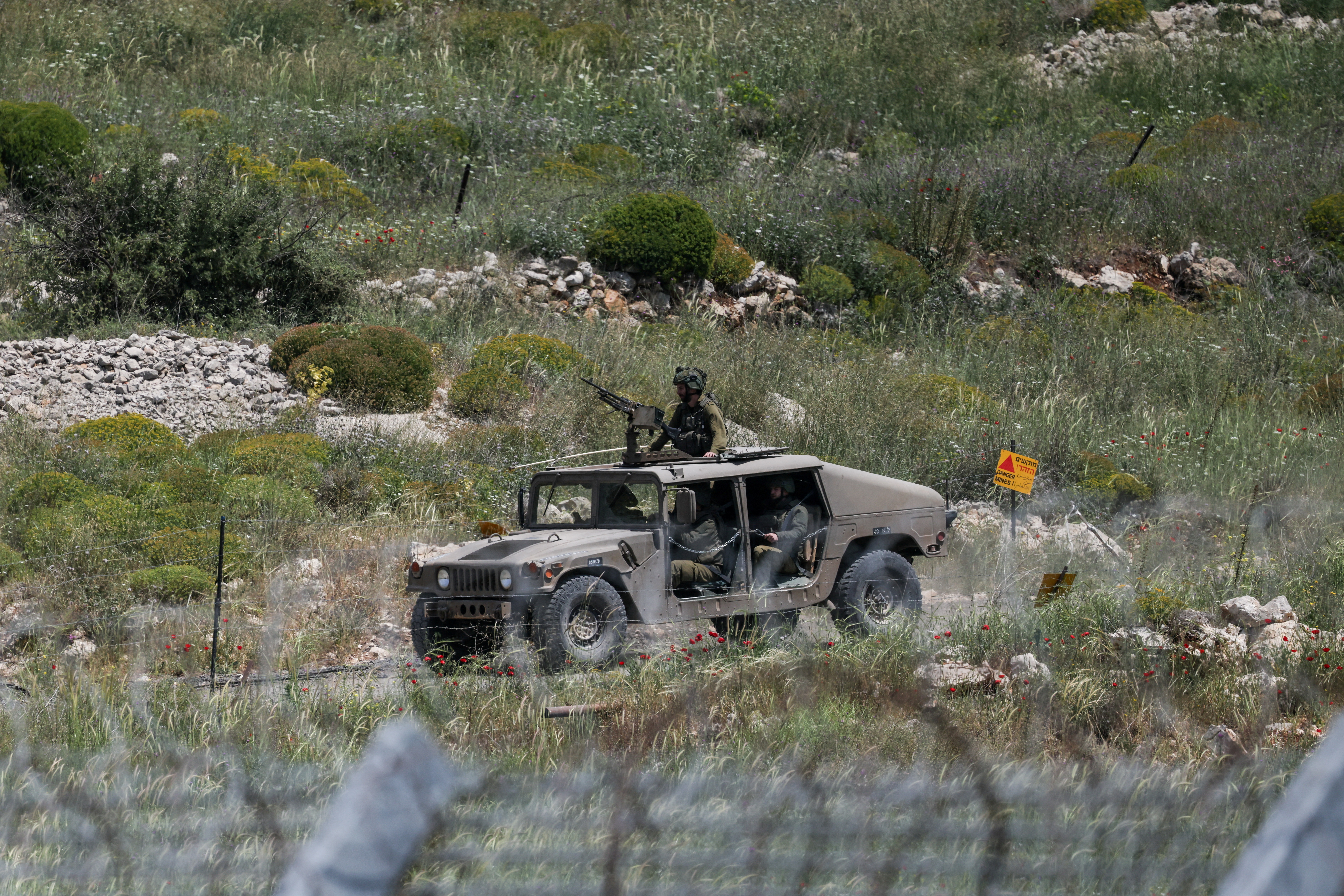 An Israeli military vehicle is seen near the border between the occupied Golan Heights and Syria