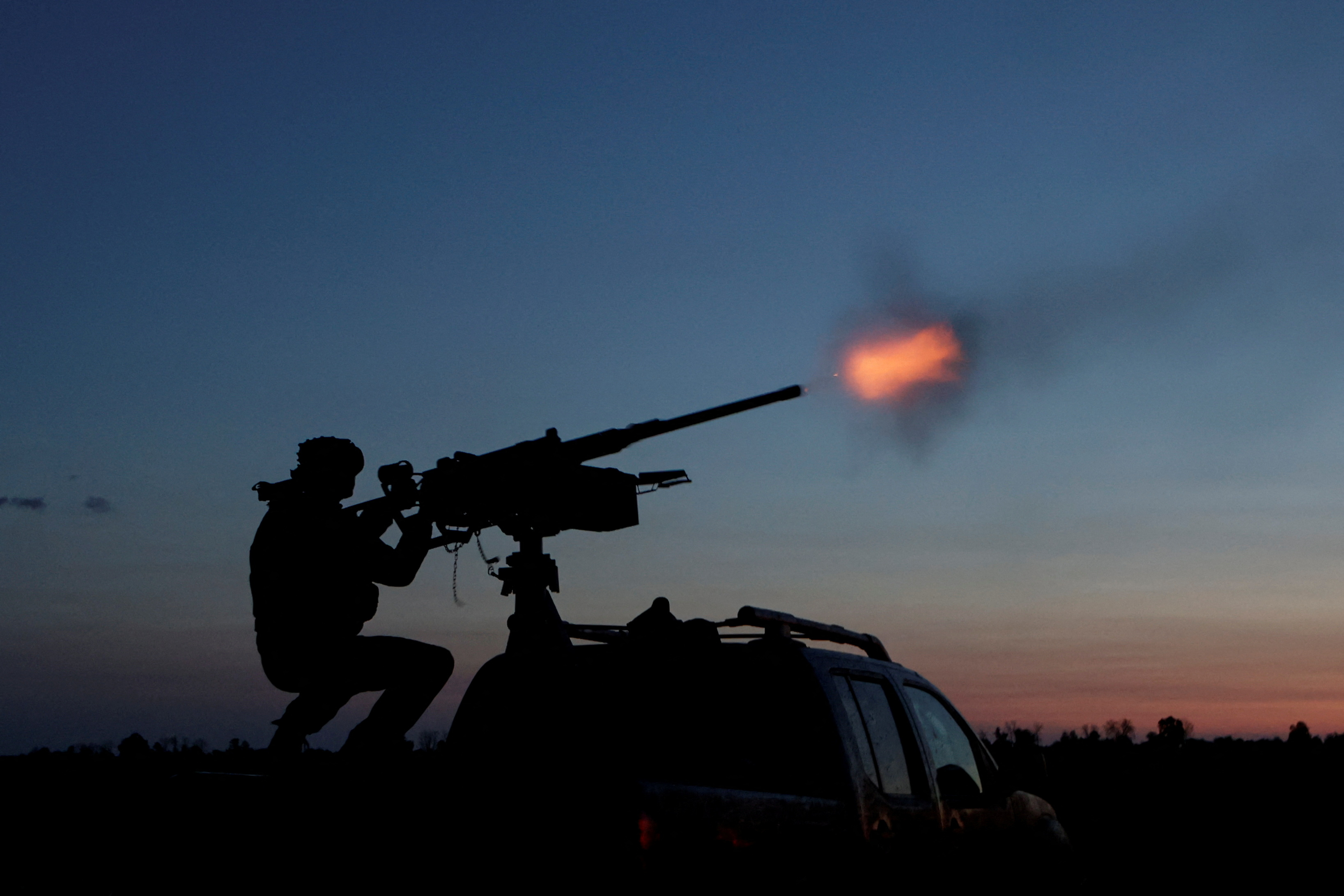 A serviceman from the mobile air defence unit of the 115th Separate Mechanized Brigade of the Ukrainian Armed Forces fires a Browning machine gun towards a Russian drone during an overnight shift, amid Russia's attack on Ukraine, in Kharkiv Region, Ukraine June 2, 2025. REUTERS/Sofiia Gatilova TPX IMAGES OF THE DAY