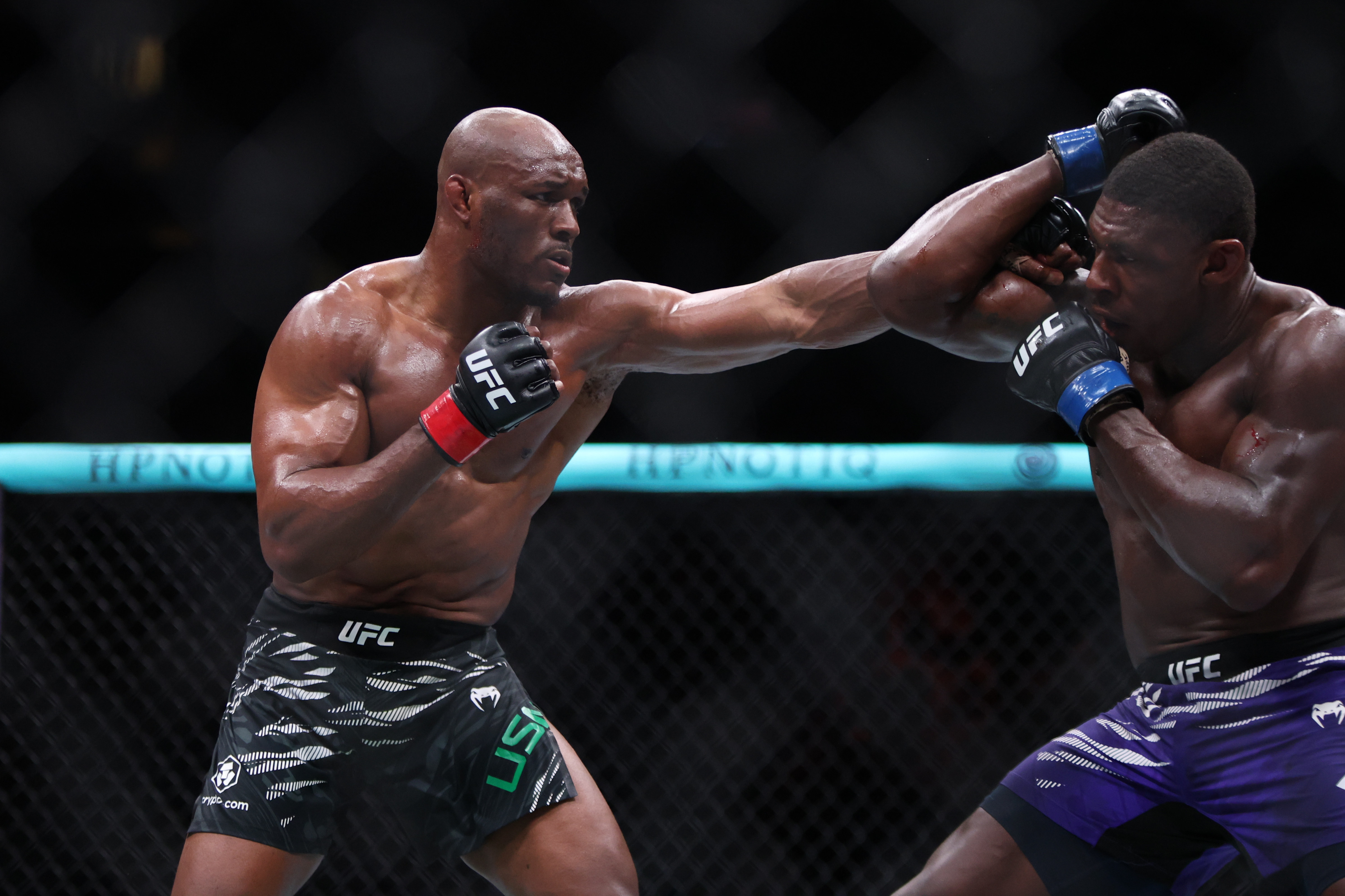 Jun 14, 2025; Atlanta, Georgia, UNITED STATES; Kamaru Usman (red gloves) fights Joaquin Buckley (blue gloves) during UFC Fight Night at State Farm Arena. Mandatory Credit: Brett Davis-Imagn Images