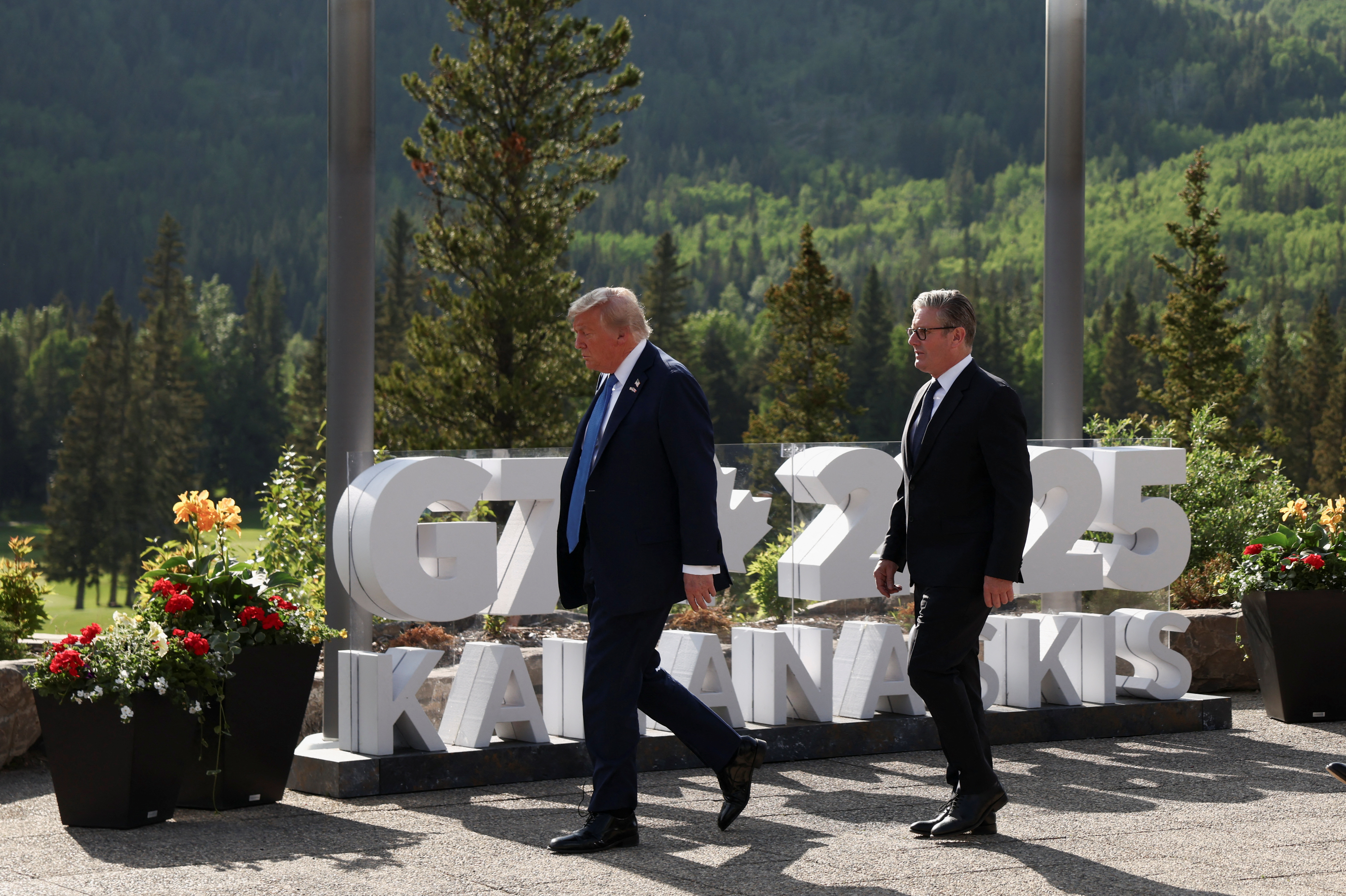 U.S. President Donald Trump and British Prime Minister Keir Starmer walk ahead of a family photo at the G7 Summit in Kananaskis, Alberta, Canada, June 16, 2025. REUTERS/Kevin Lamarque
