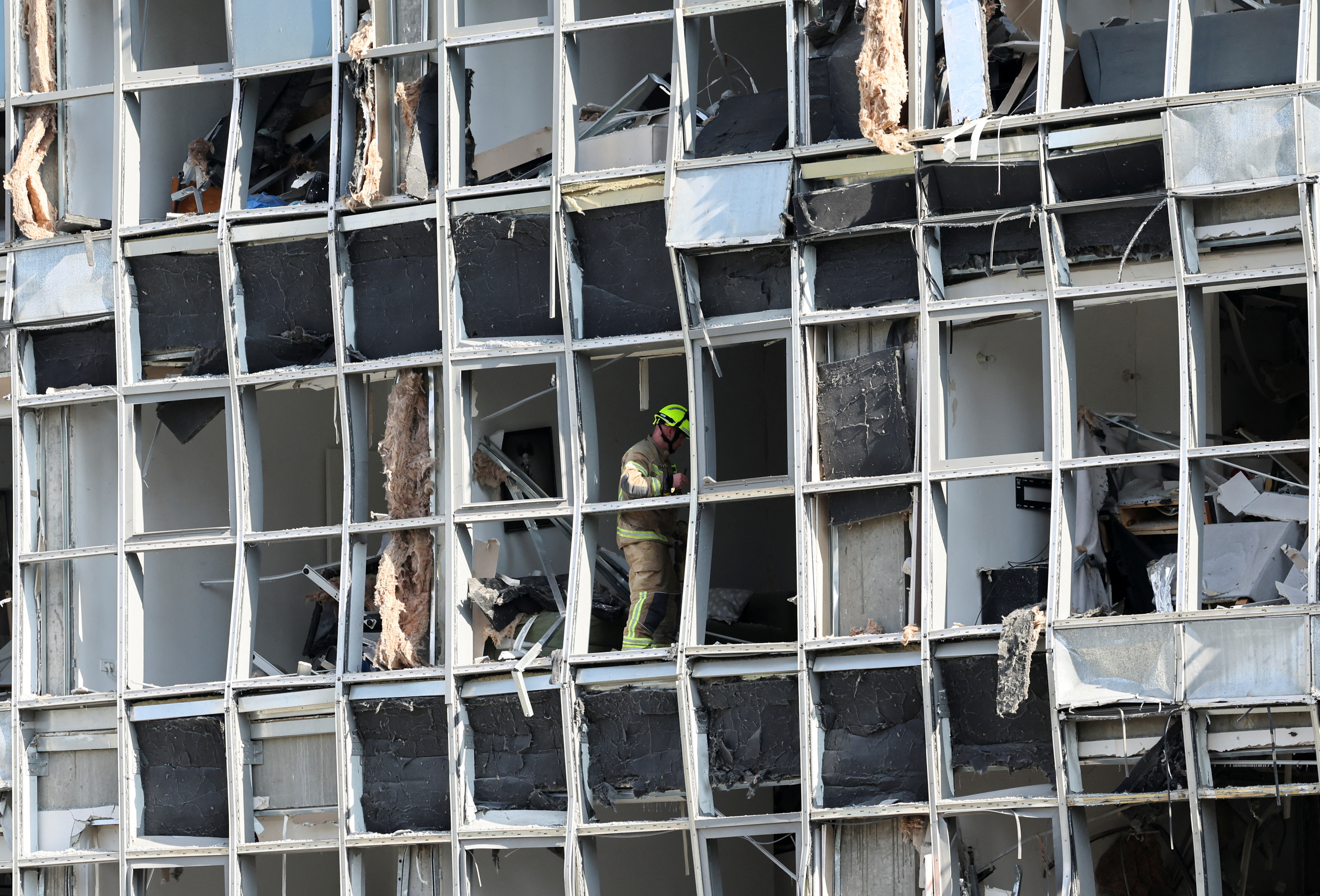 A rescuer stands inside a damaged building following a strike from Iran on Israel, in Ramat Gan, Israel June 19, 2025. REUTERS/Nir Elias