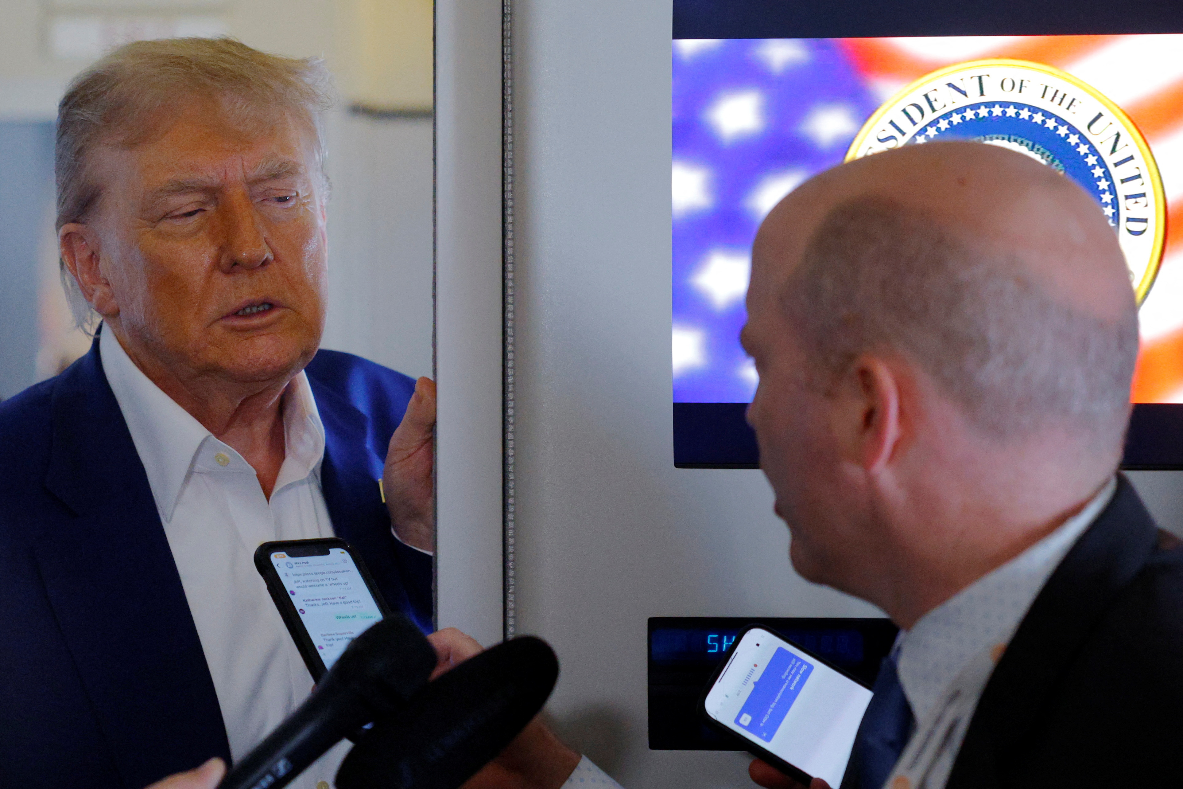 U.S. President Donald Trump speaks to reporters onboard Air Force One en route to the NATO summit in The Hague, Netherlands, June 24, 2025.