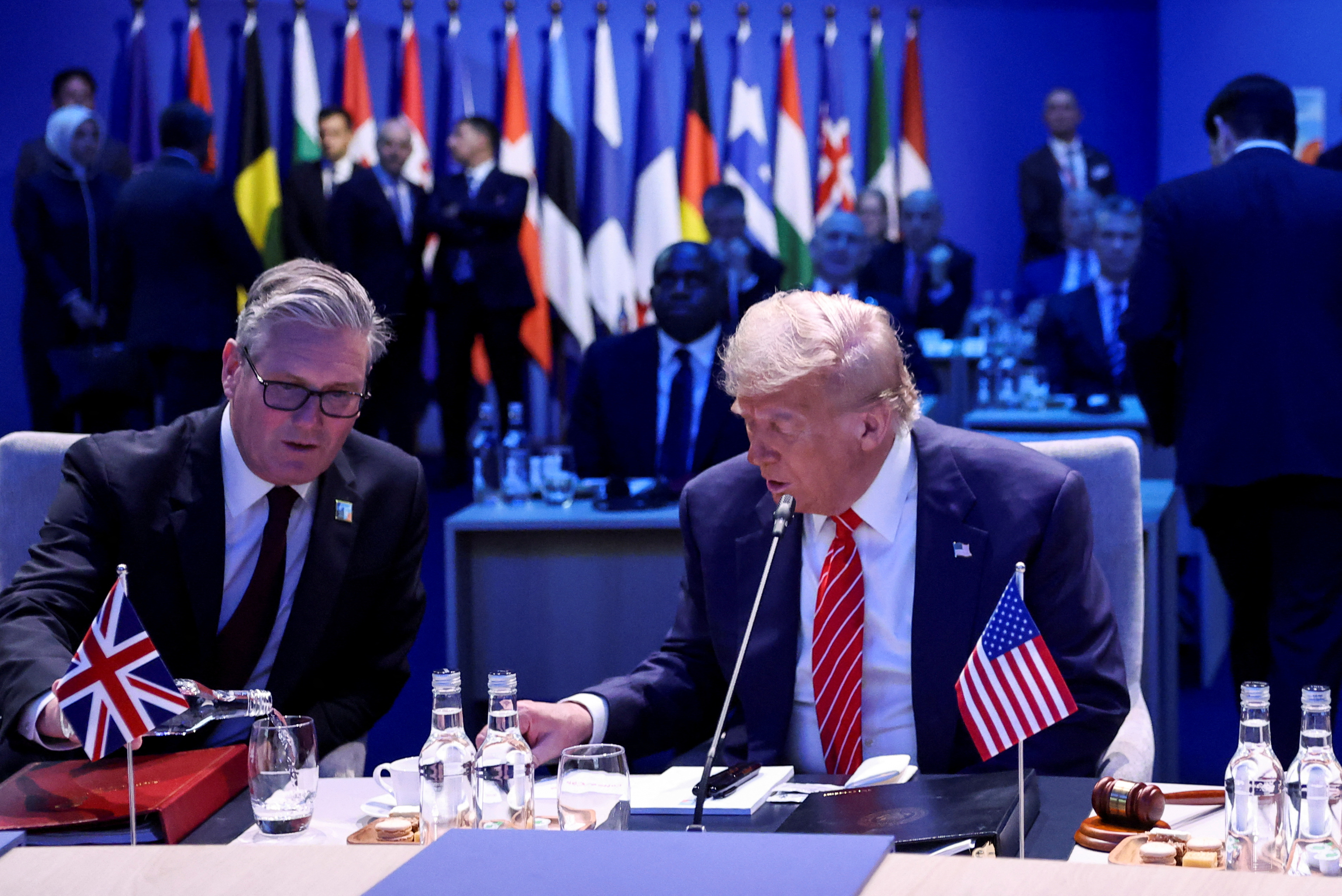 Britain's Prime Minister Keir Starmer and US President Donald Trump attend a meeting of the North Atlantic Council (NAC) during a NATO summit in The Hague, Netherlands June 25, 2025. [Toby Melville/Reuters]