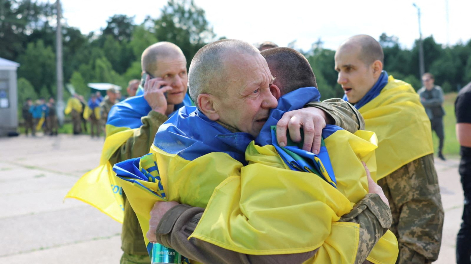 Ukrainian prisoners of war (POWs) react after a swap, amid Russia's attack on Ukraine, at an unknown location in Ukraine