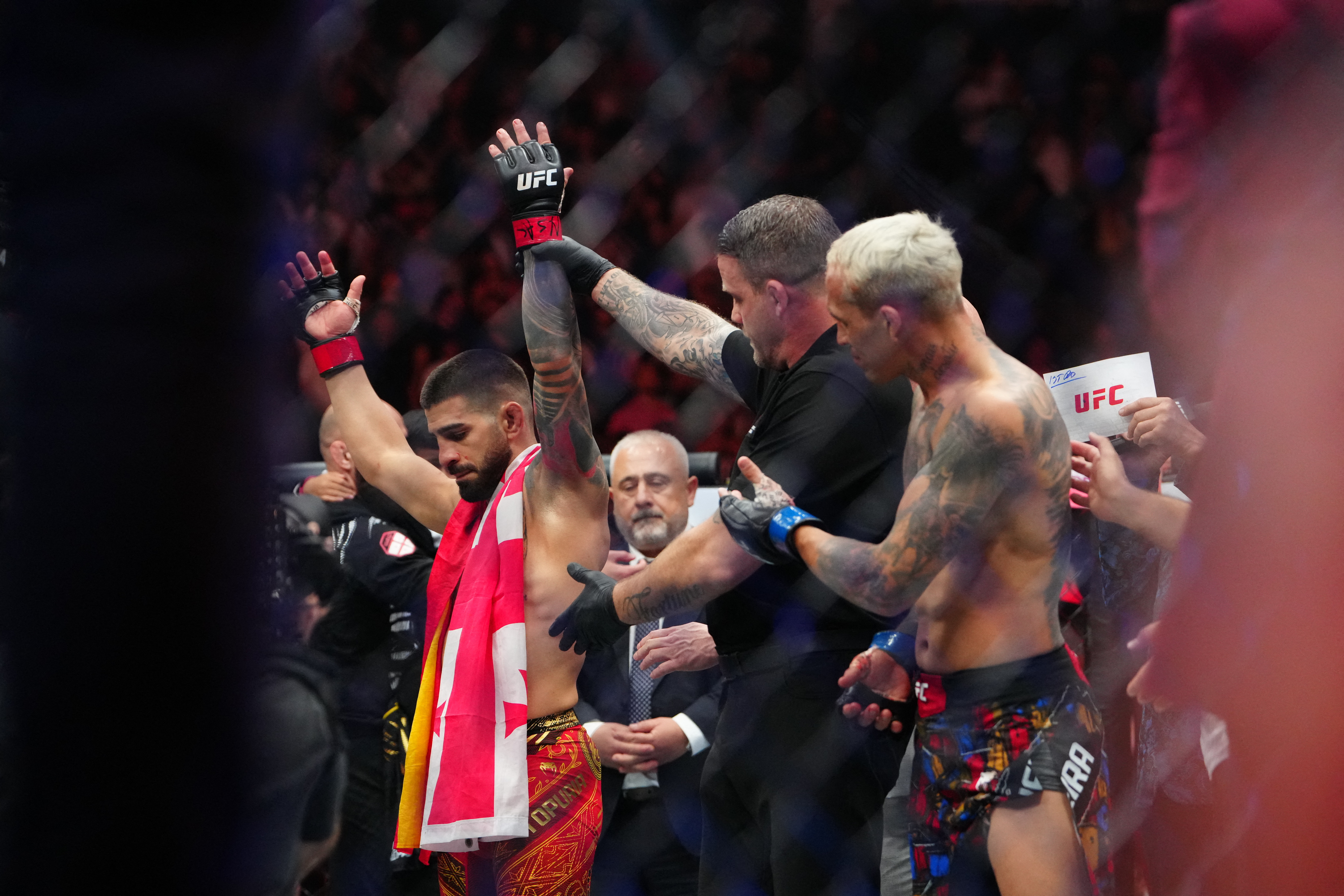 Topuria raises his hands in victory