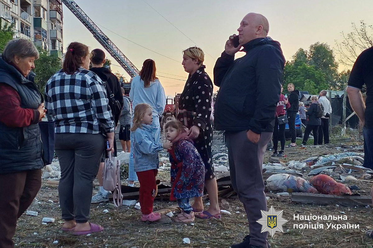 Residents stand in front of their apartment building damaged during Russian drone and missile strikes, amid Russia's attack on Ukraine, in the town of Smila, Cherkasy region, Ukraine June 29, 2025. Press service of the National Police of Ukraine in Cherkasy region/Handout via REUTERS ATTENTION EDITORS - THIS IMAGE HAS BEEN SUPPLIED BY A THIRD PARTY. DO NOT OBSCURE LOGO.