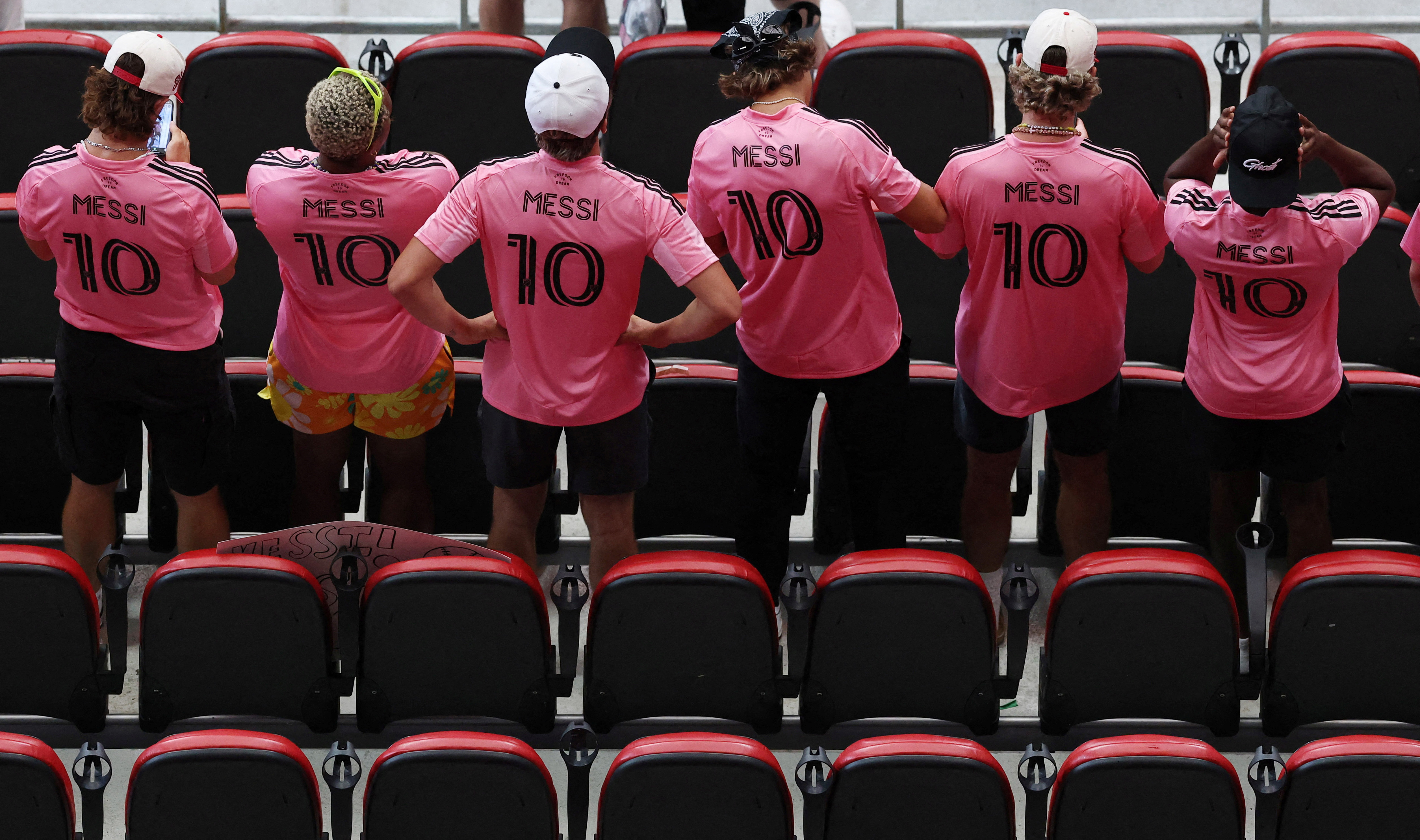 Soccer Football - FIFA Club World Cup - Round of 16 - Paris St Germain v Inter Miami CF - Mercedes-Benz Stadium, Atlanta, Georgia, U.S. - June 29, 2025 Fan wearing Inter Miami CF's Lionel Messi shirts are pictured in the stands before the match REUTERS/Amanda Perobelli TPX IMAGES OF THE DAY