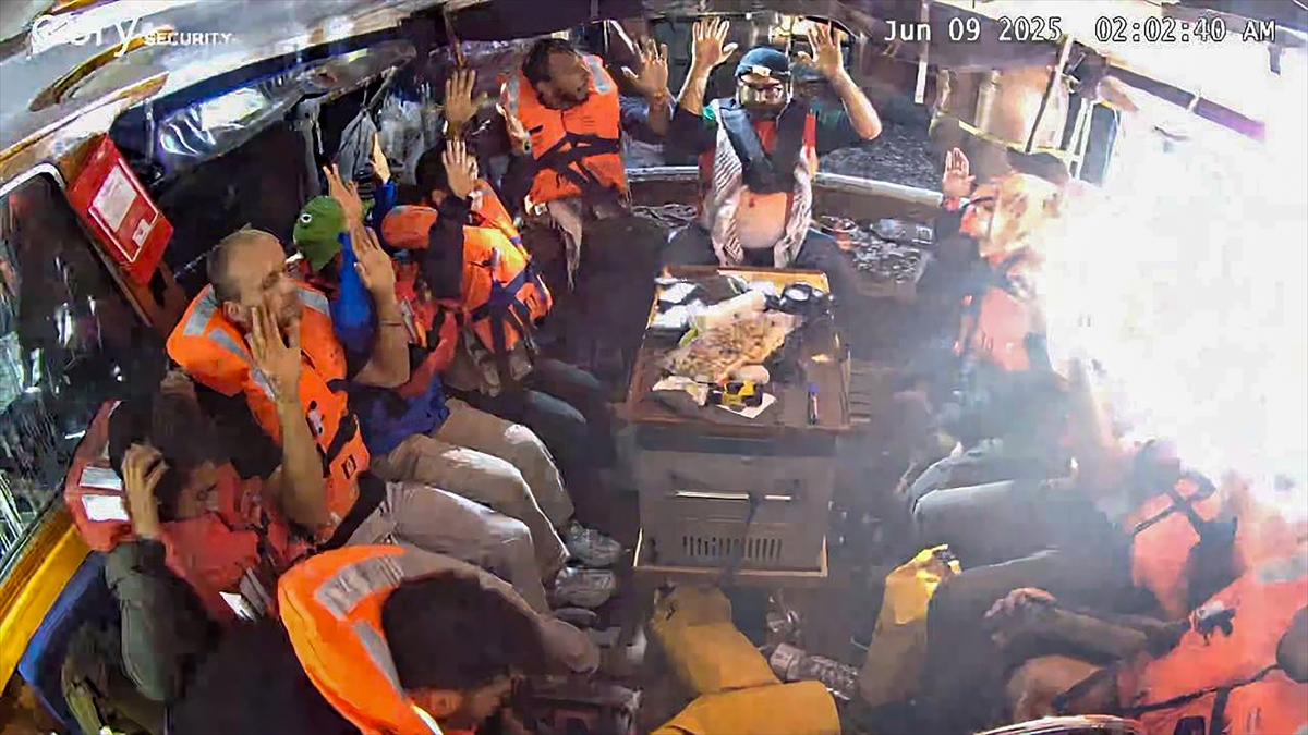 An image grab from footage released by the Freedom Flotilla Coalition on June 9, 2025 shows activists on board the Gaza-bound aid boat Madleen, with their hands in the air, as they are being intercepted by the Israeli forces in international waters before reaching the blockaded Palestinian territory.