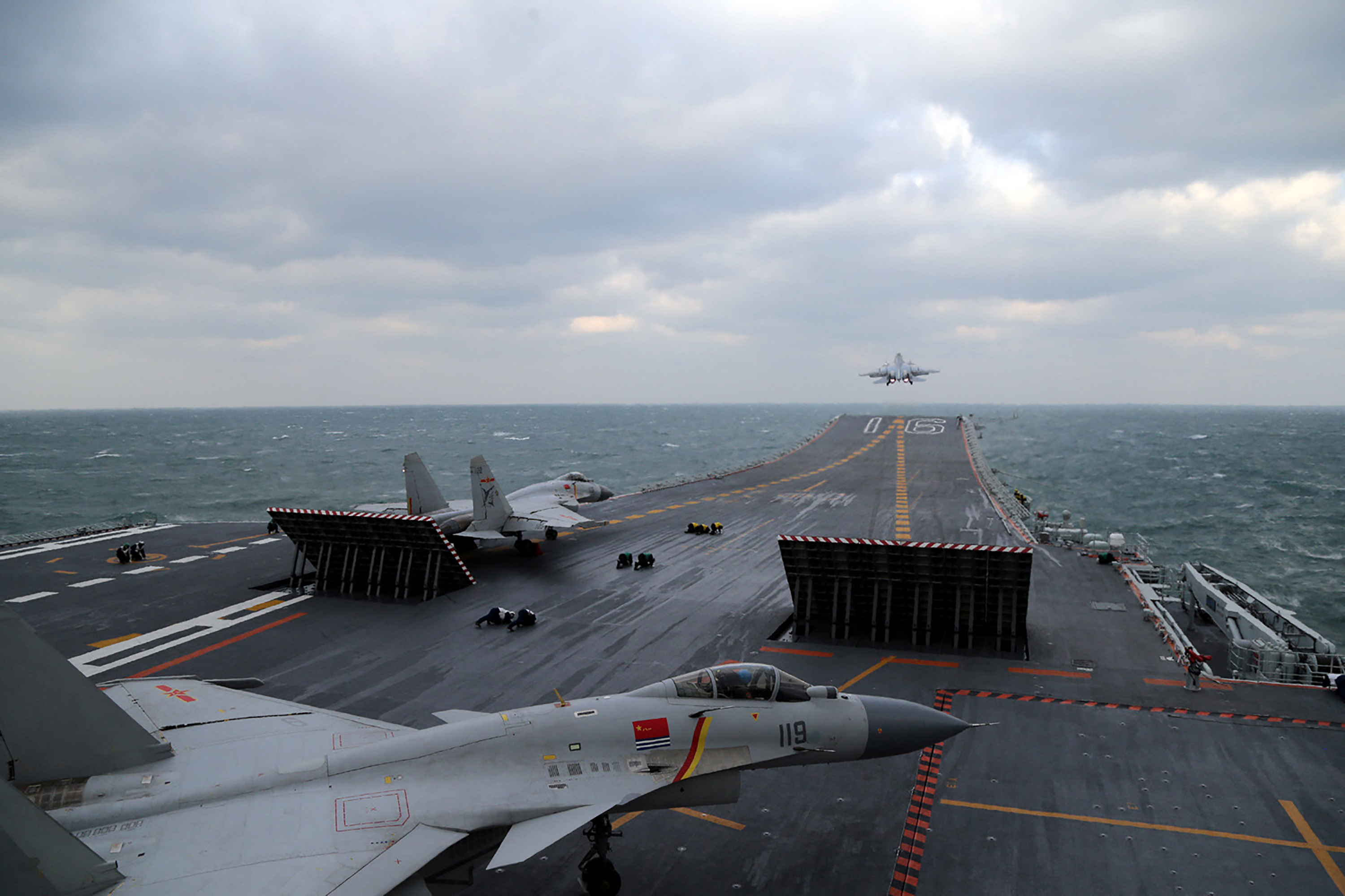 This photo taken on December 23, 2016 shows Chinese J-15 fighter jets being launched from the deck of the Liaoning aircraft carrier during military drills in the Yellow Sea, off China's east coast. Taiwan's defence minister warned on December 27 that enemy threats were growing daily after China's aircraft carrier and a flotilla of other warships passed south of the island in an exercise as tensions rise. (Photo by AFP) / China OUT / CHINA OUT