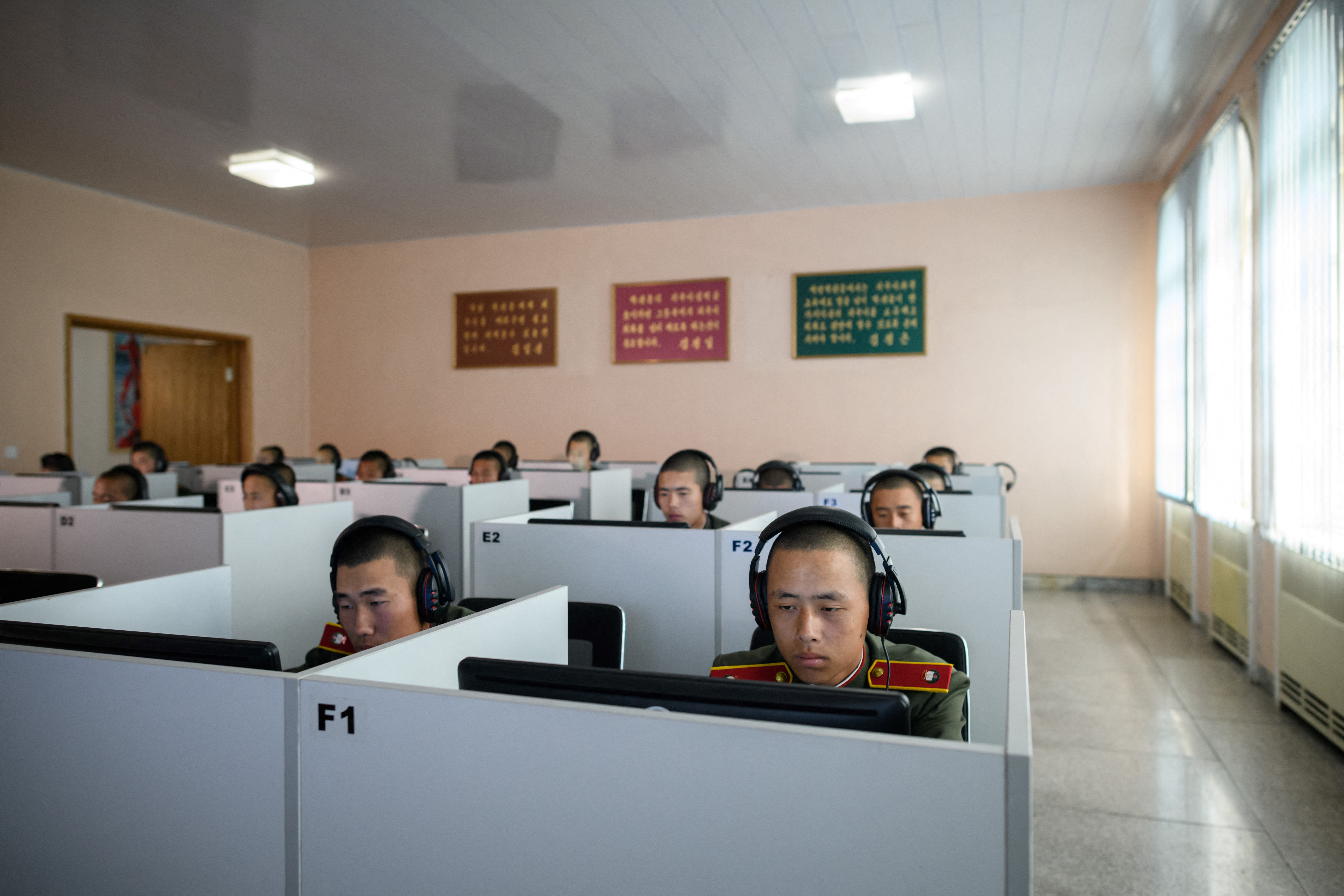 In a photo taken on June 14, 2018, students wearing Korean People's Army (KPA) uniforms sit before computer screens as they attend a class at the Mangyongdae Revolutionary School outside Pyongyang. Nuclear-armed North Korea is advancing on the front lines of cyberwarfare, analysts say, stealing billions of dollars and presenting a clearer and more present danger than its banned weapons programmes. (Photo by Ed JONES / AFP) / TO GO WITH IT-SECURITY-NKOREA-US-DIPLOMACY,FOCUS BY SUNGHEE HWANG