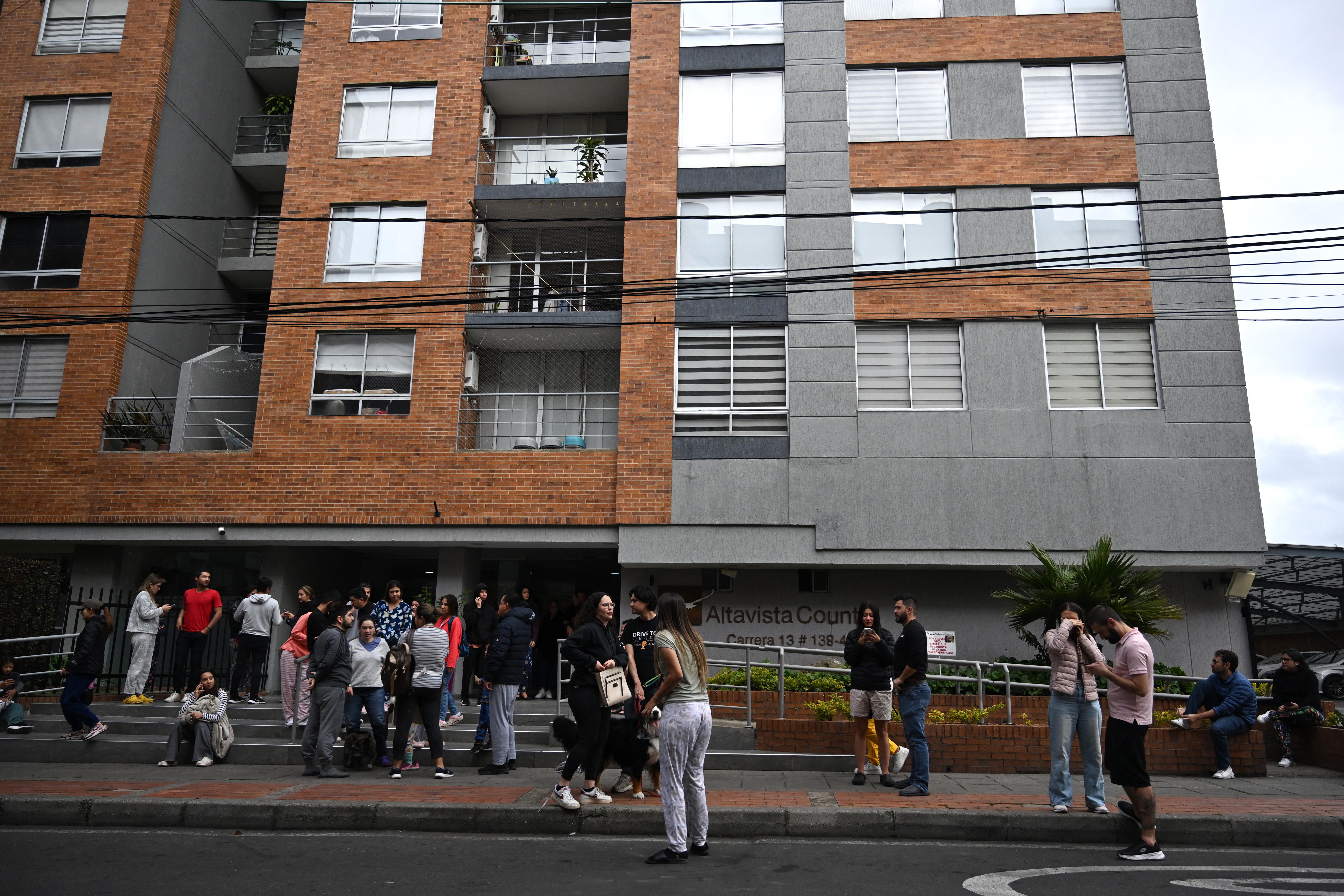 People remain on the street after an earthquake shakes Bogota, Colombia