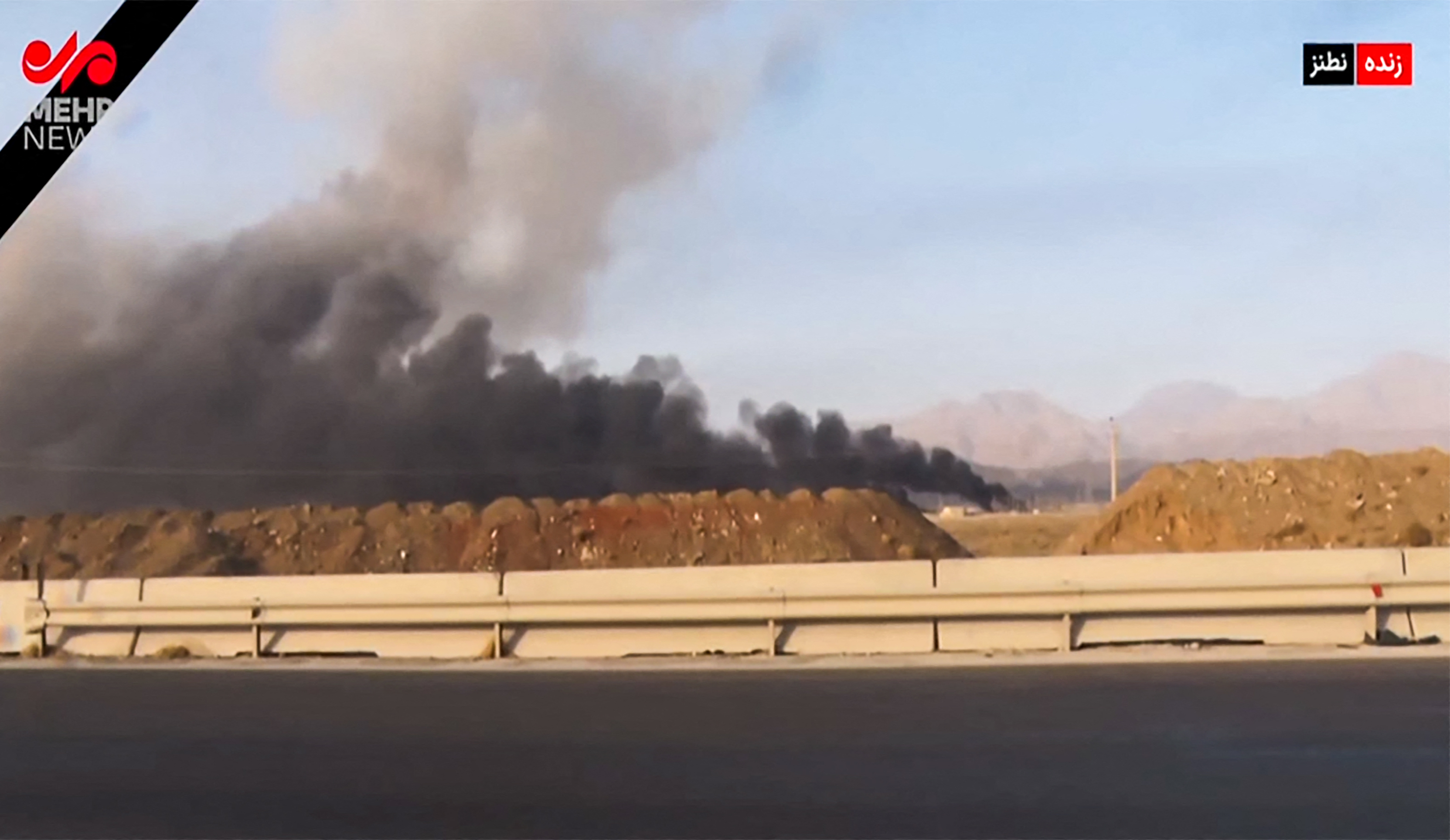 image grab taken from footage broadcast by Iran's IRINN news on June 13, 2025 shows what the television described as smoke billowing from explosions in Natanz