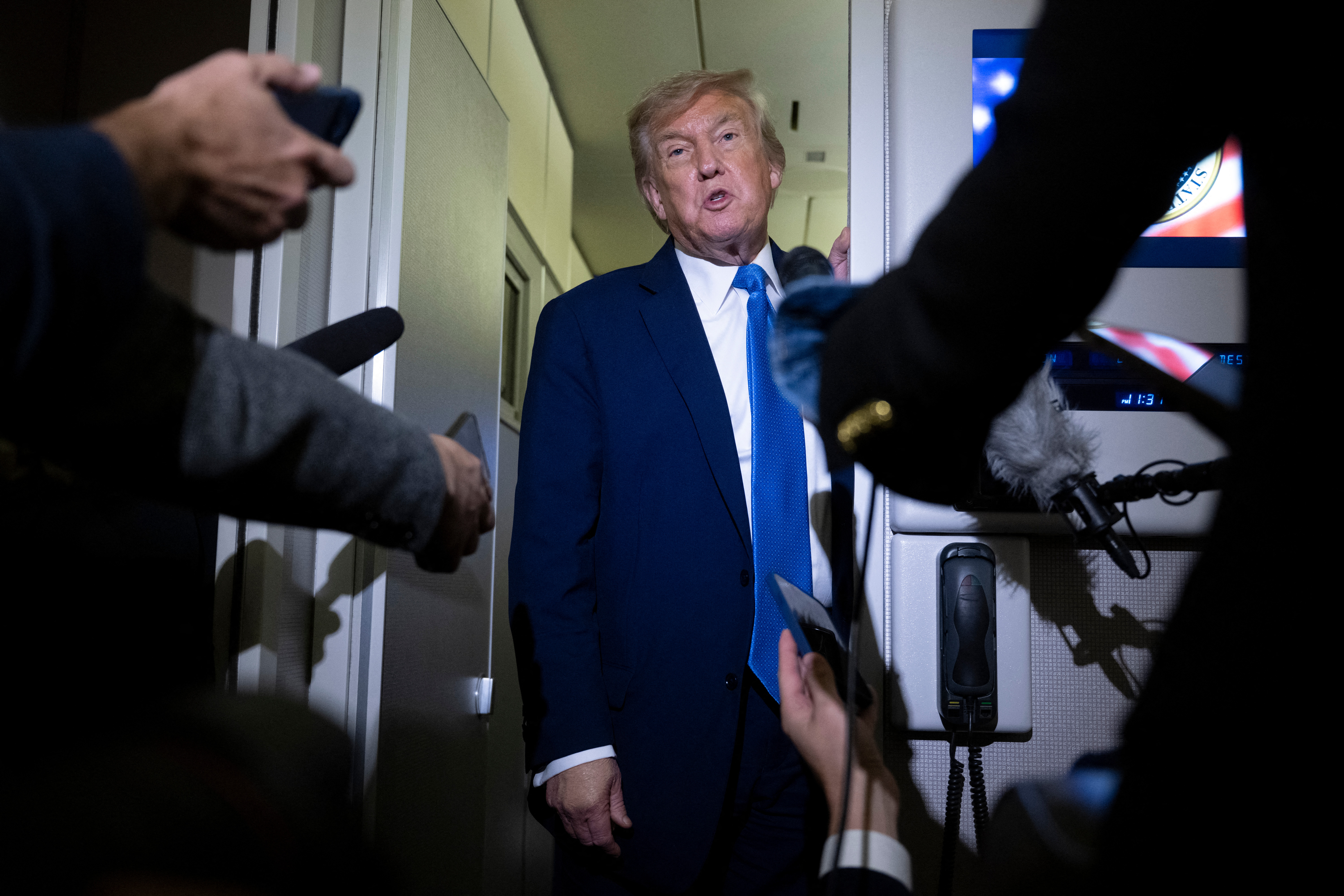 US President Donald Trump speaks to reporters about the G7 Summit aboard Air Force One while travelling back to Washington from Canada