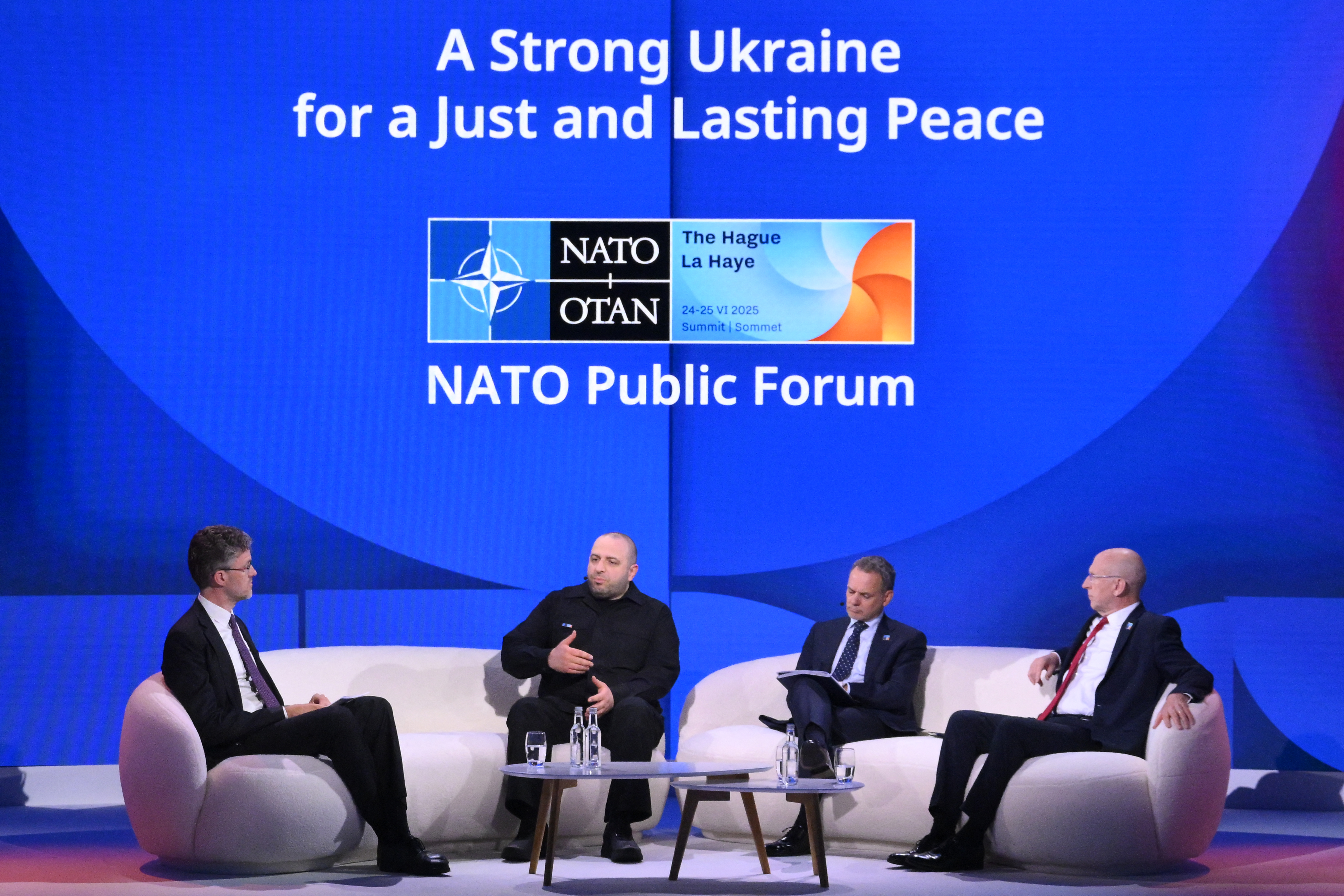 Ukraine's Defence Minister Rustem Umerov (2ndL), Dutch Foreign Affairs Minister Caspar Veldkamp and Britain's Defence Secretary John Healey take part in a NATO public forum on "A Strong Ukraine for a Just and Lasting Peace" as part of a NATO summit in The Hague on June 24, 2025.