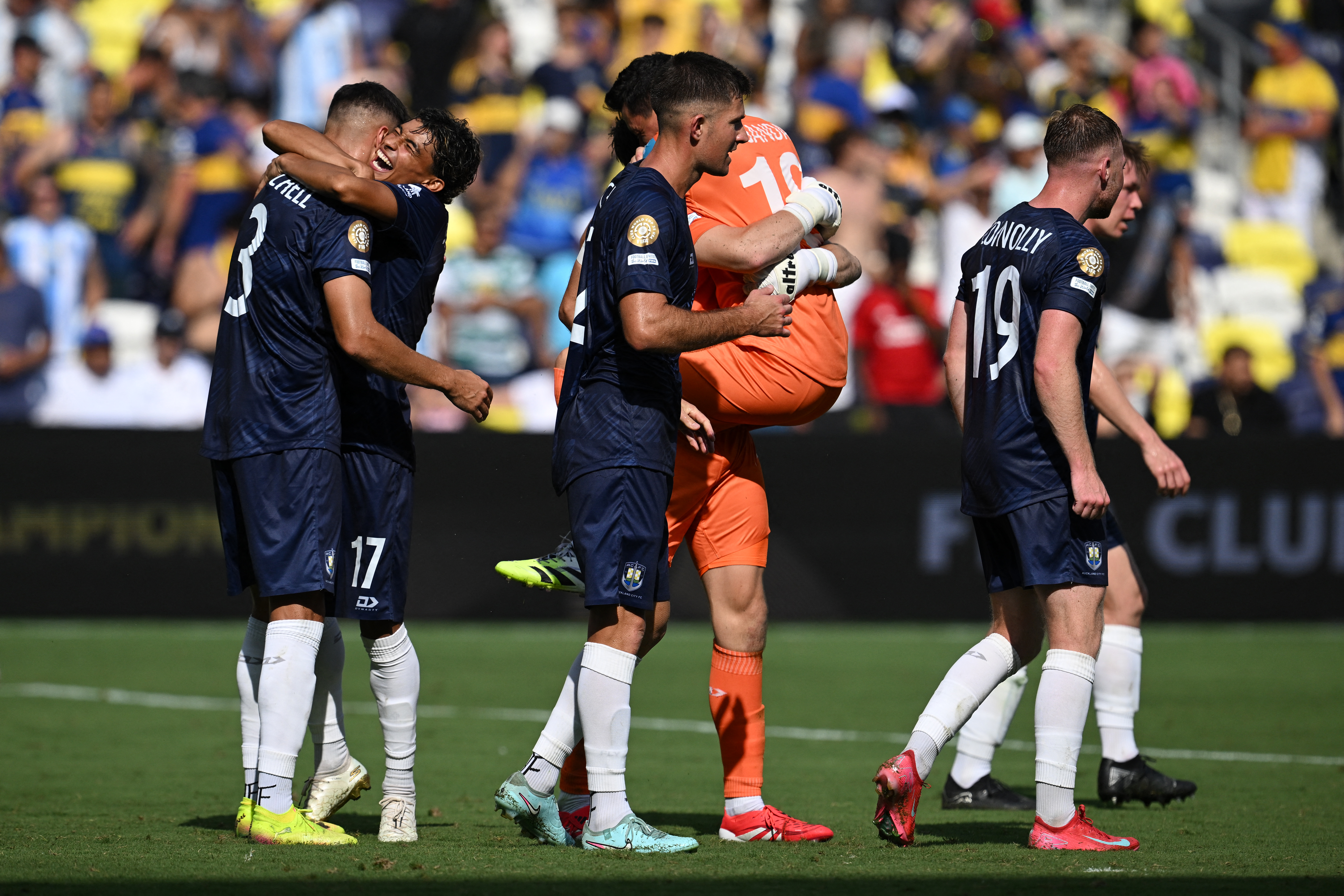 Auckland City' players celebrate next to at the end of the FIFA Club World Cup 2025 Group C football match between New Zealand's Auckland City and Argentina's Boca Juniors at the Geodis Park stadium in Nashville on June 24, 2025. (Photo by Federico PARRA / AFP)