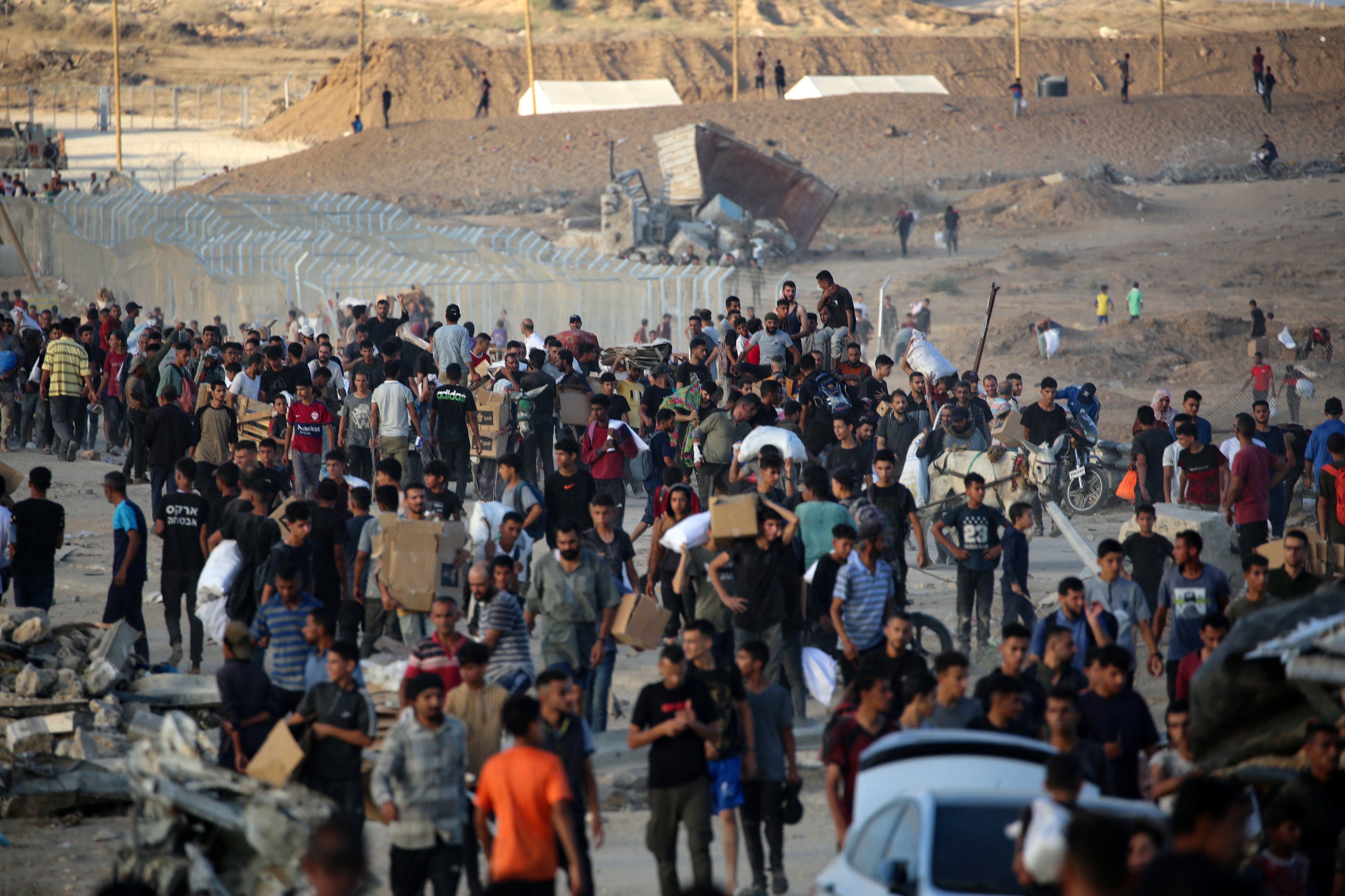 Palestinians gather at an aid distributution point set up by the privately-run Gaza Humanitarian Foundation (GHF), near the Nuseirat refugee camp in the central Gaza Strip on June 25, 2025.