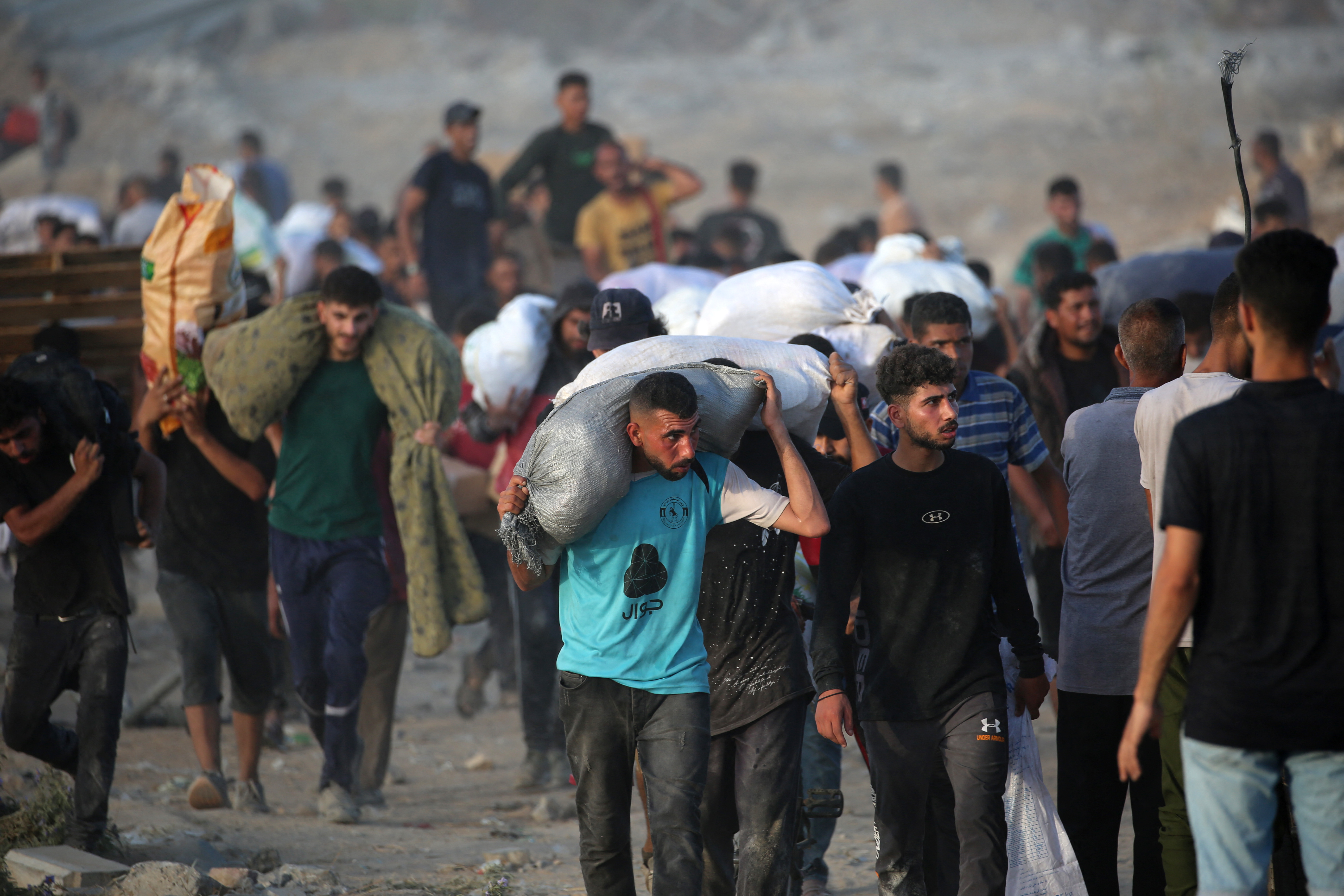 People walking and carrying aid parcels.