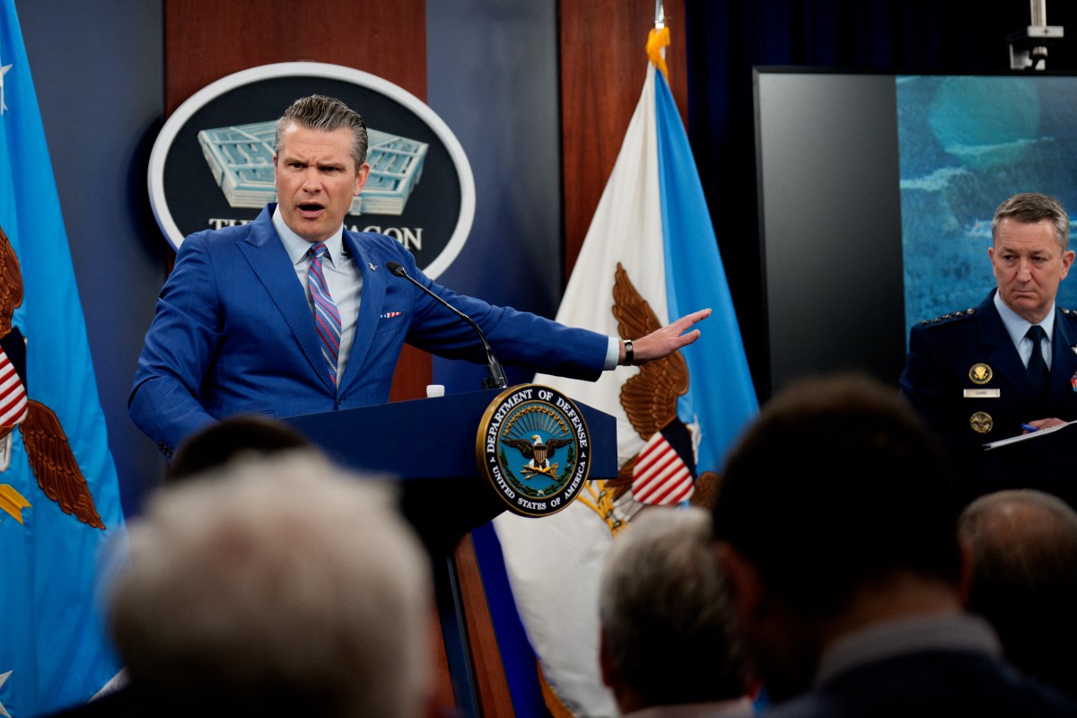 US Defense Secretary Pete Hegseth (L) and Chairman of the Joint Chiefs of Staff Dan Caine speak during a news conference at the Pentagon.