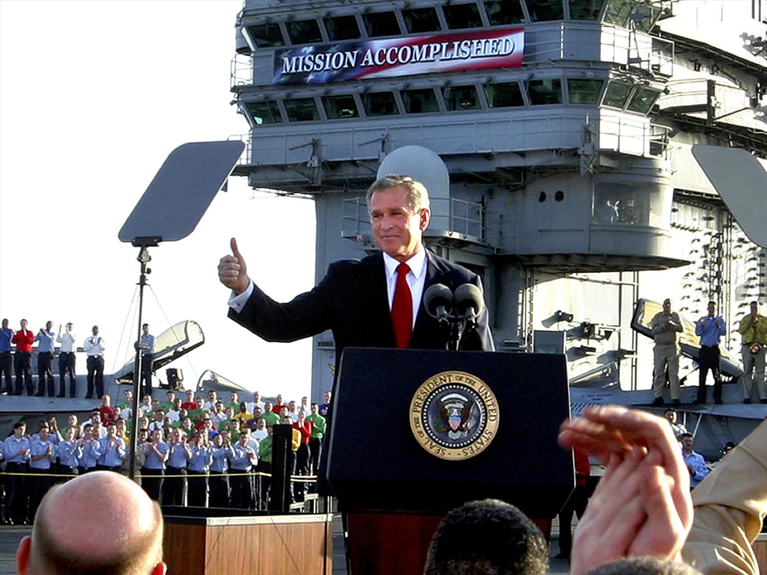 George W Bush, as US President, gives a thumbs-up.